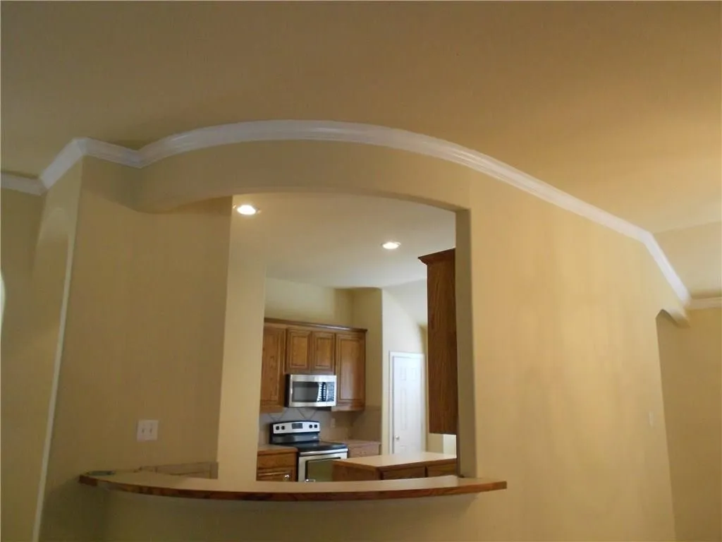 Arched pass-through with a wood-finish bar top