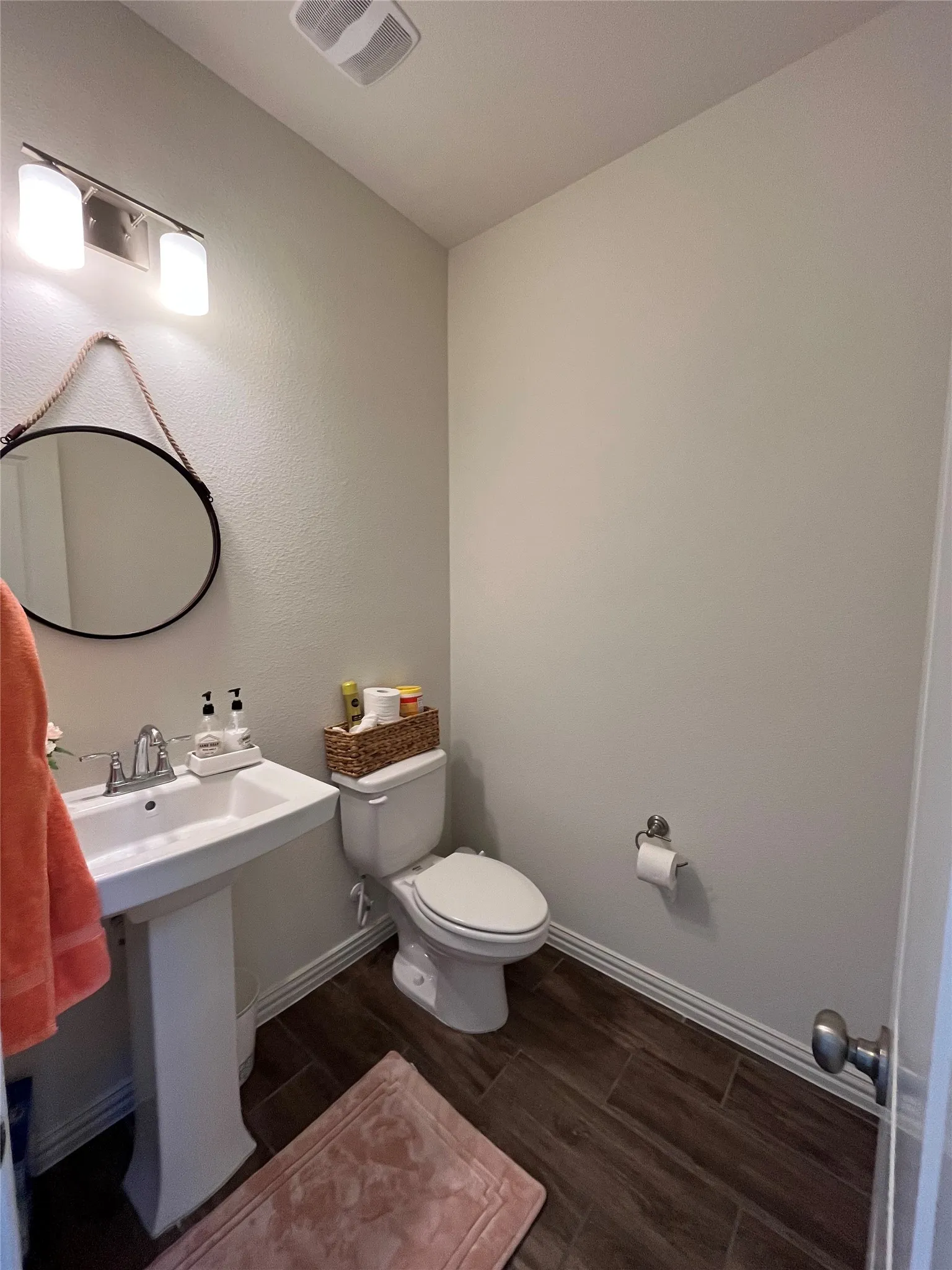 Powder Bathroom Downstairs featuring hardwood / wood-style floors