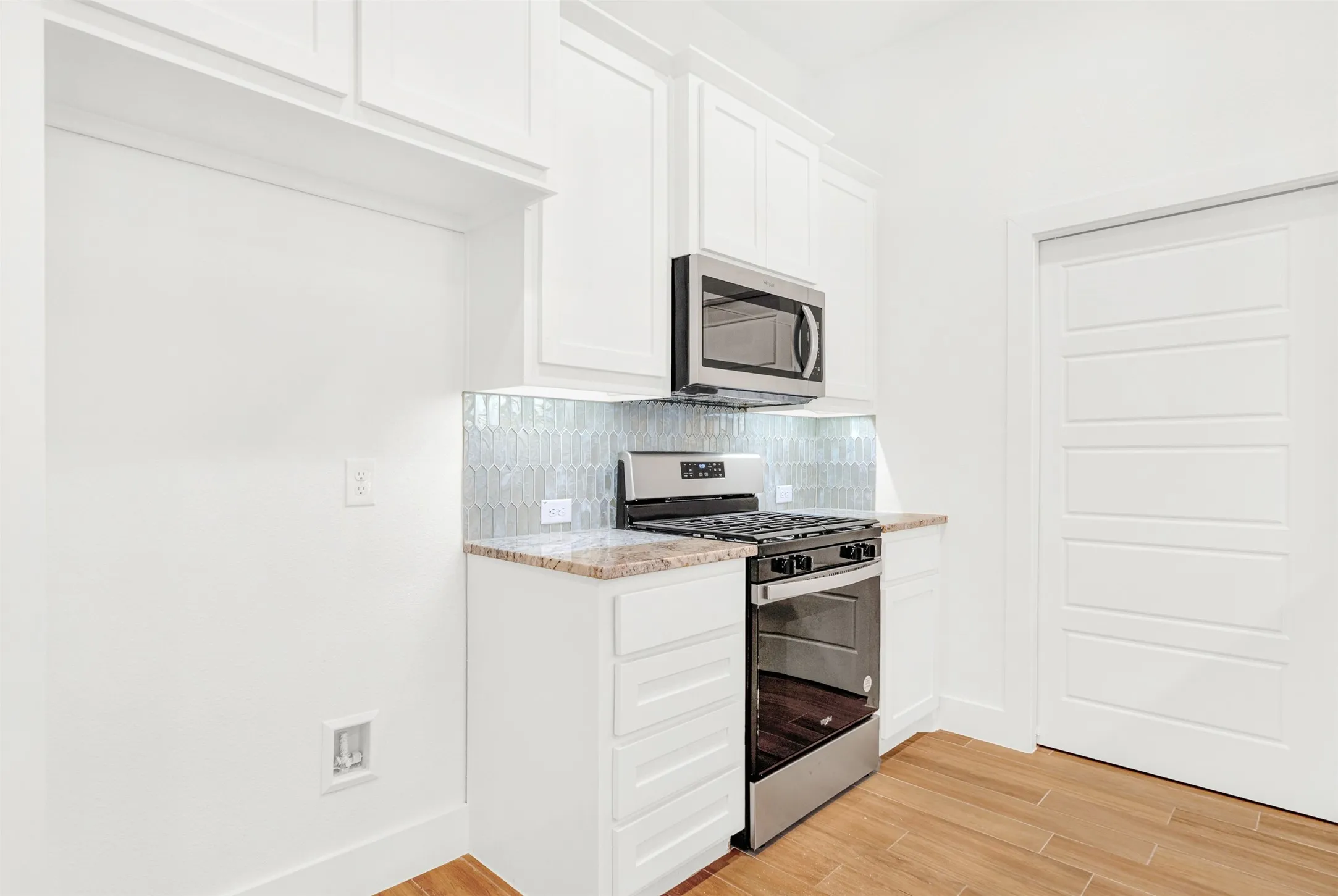 SS refrigerator(not shown) next to SS range and microwave