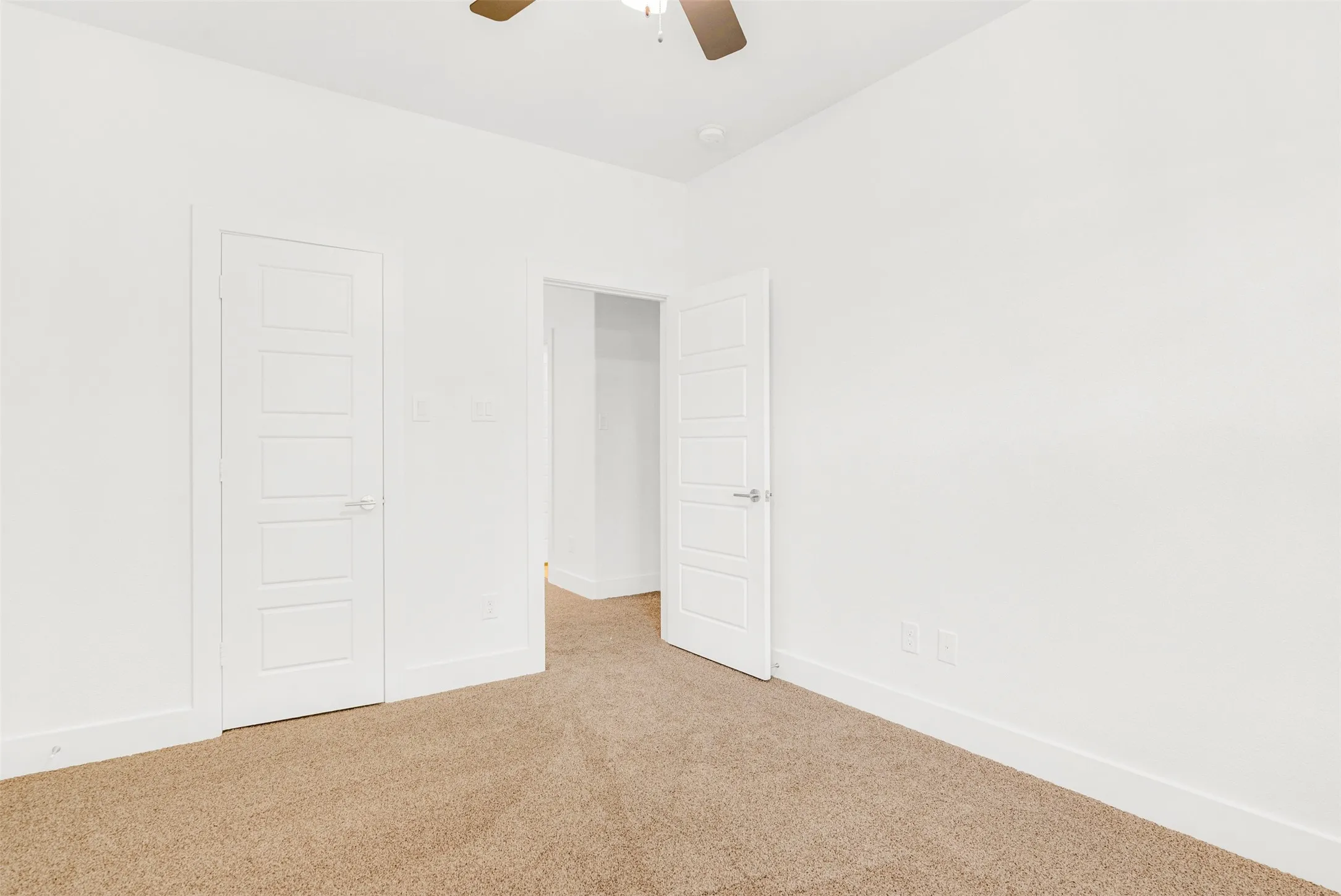 Large secondary bedroom with in-room closet has lots of natural light and  opens out to hallway and bathroom.