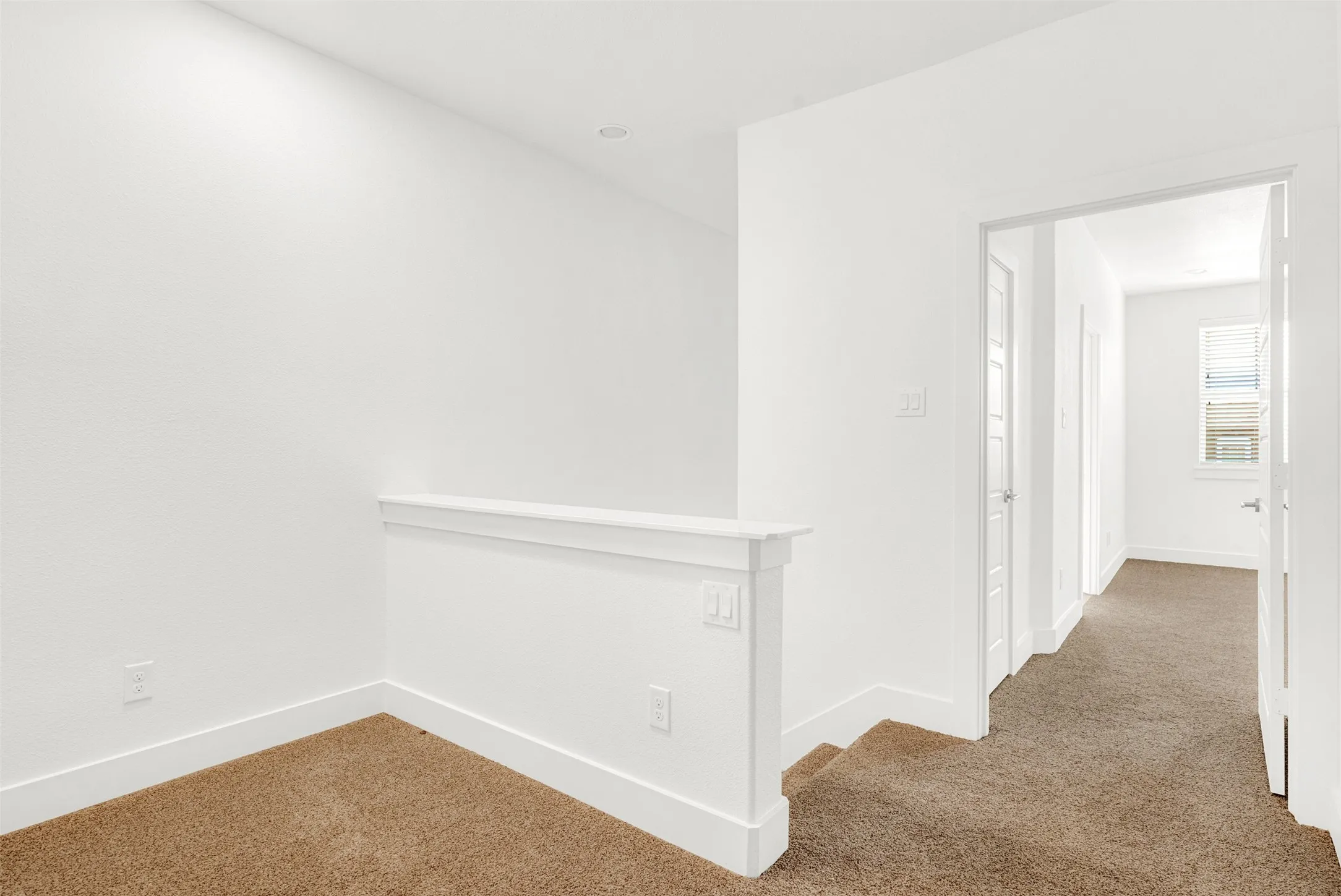 View of the second floor carpeted landing leading to upstairs master bedroom on the front with built in desk (not shown) which is perfect for those who work from home or just private desk.