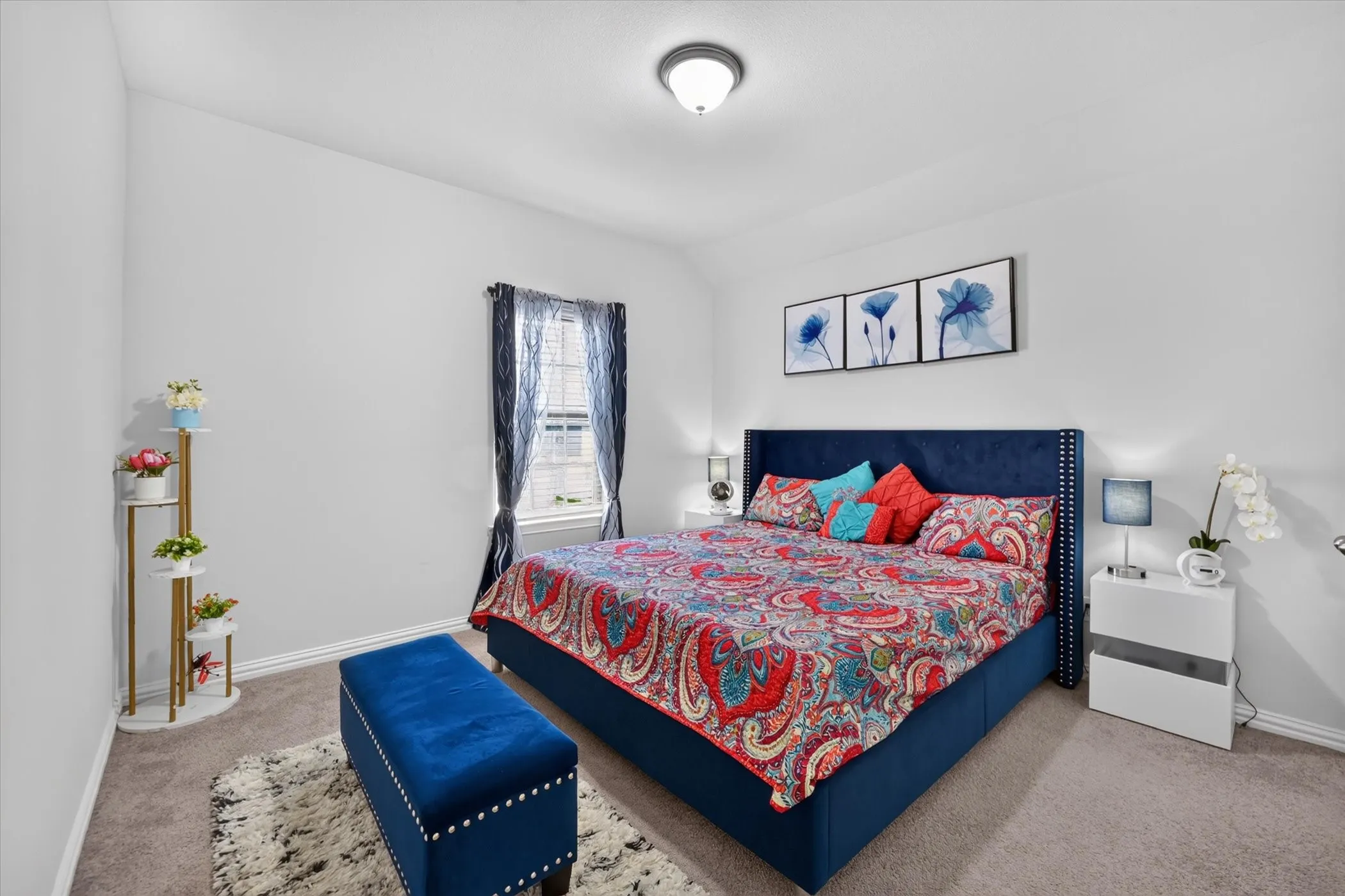 Vaulted ceiling, recessed lighting fixture, window with privacy blinds, and neutral-toned carpet flooring