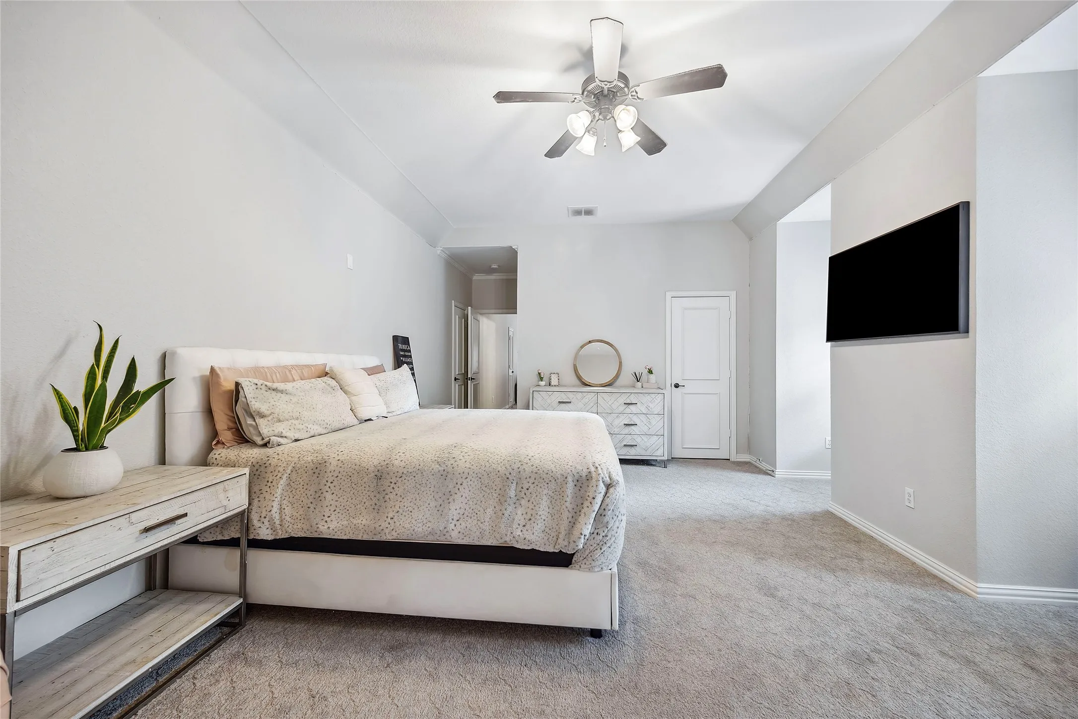 Vaulted ceiling with an attached ceiling fan, recessed lighting, and light-toned carpeting