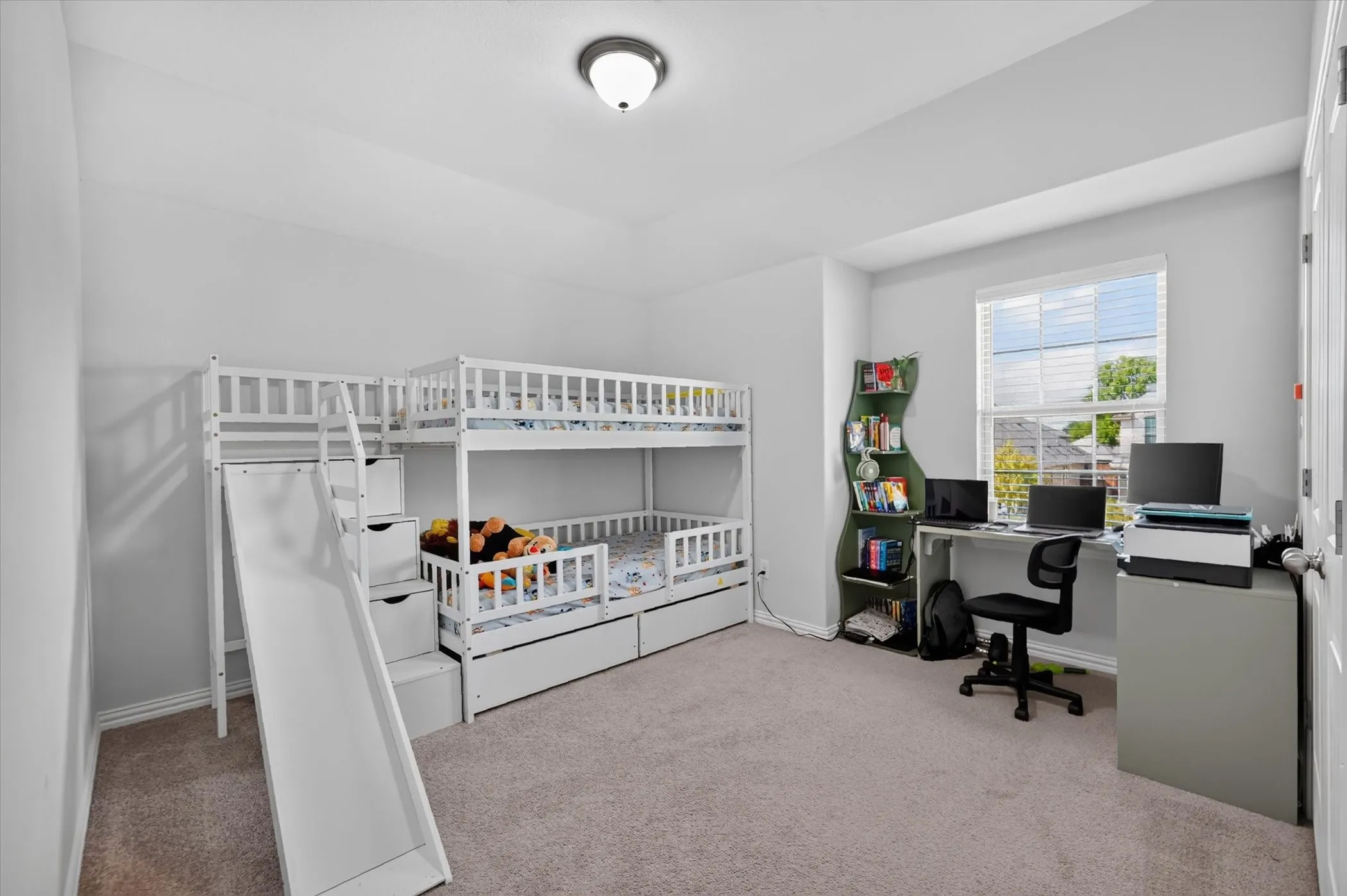 Carpeted flooring, window with blinds, and white interior walls