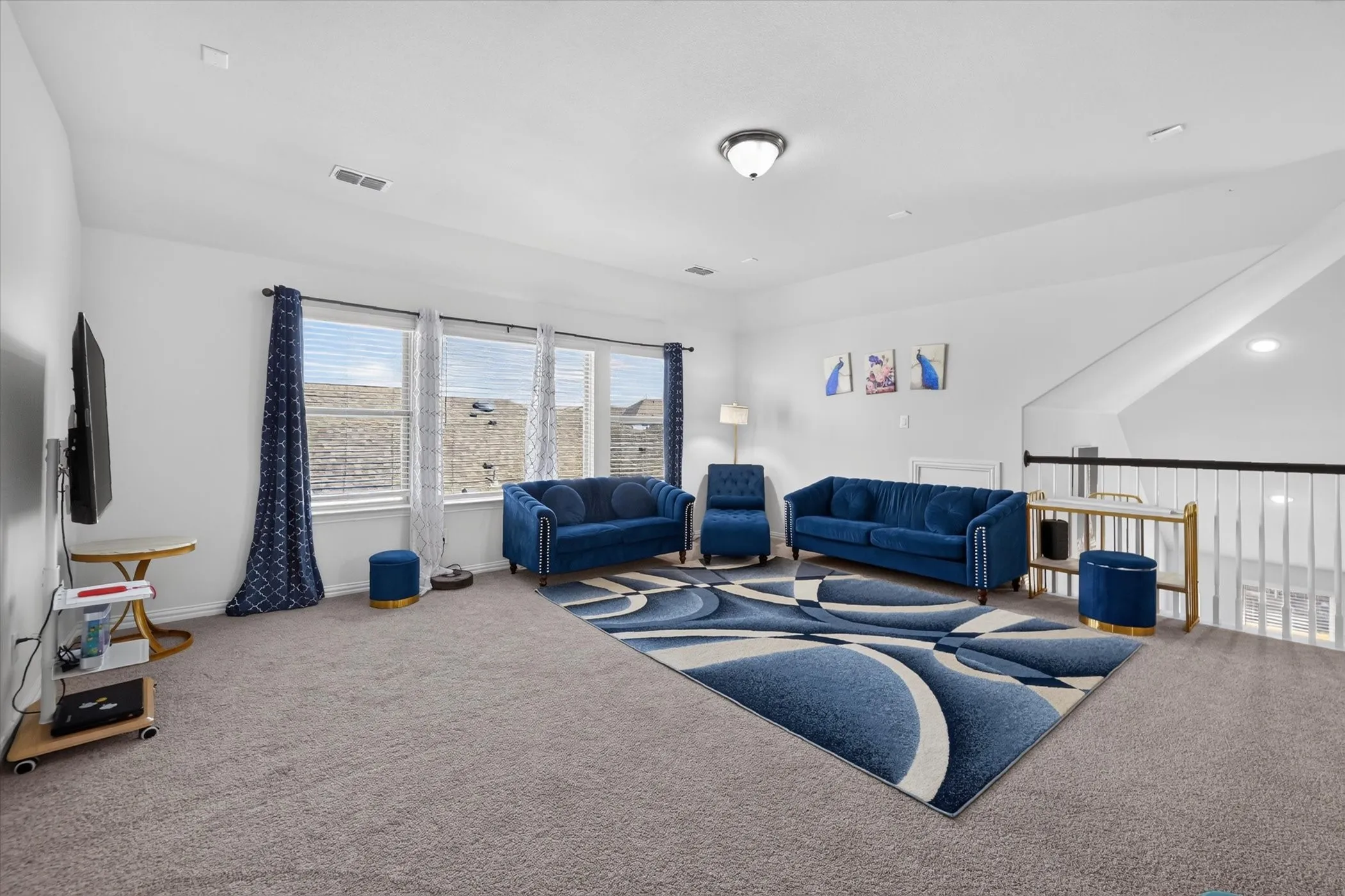 White walls with a light gray carpet and multiple windows