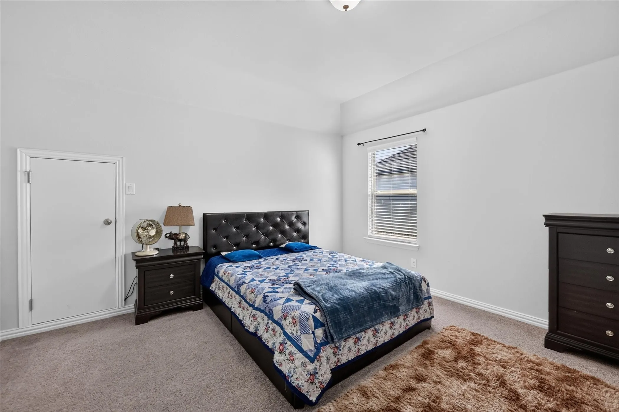 Recessed ceiling, single window with blinds, and neutral carpet flooring