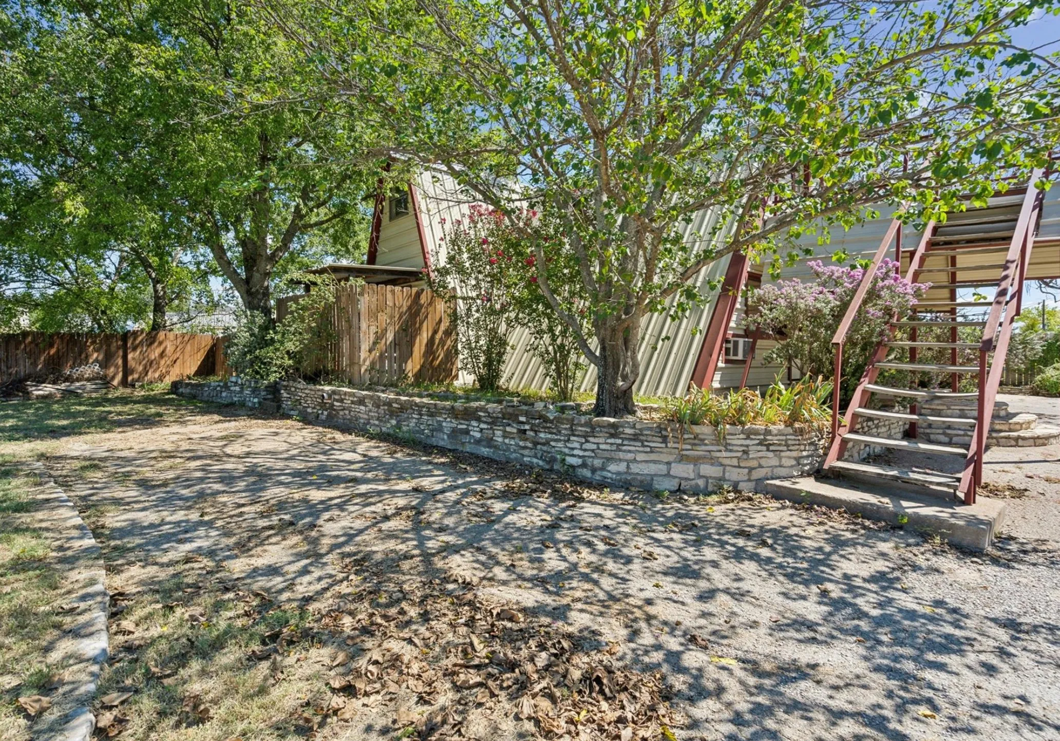 View of yard featuring stairway and fence