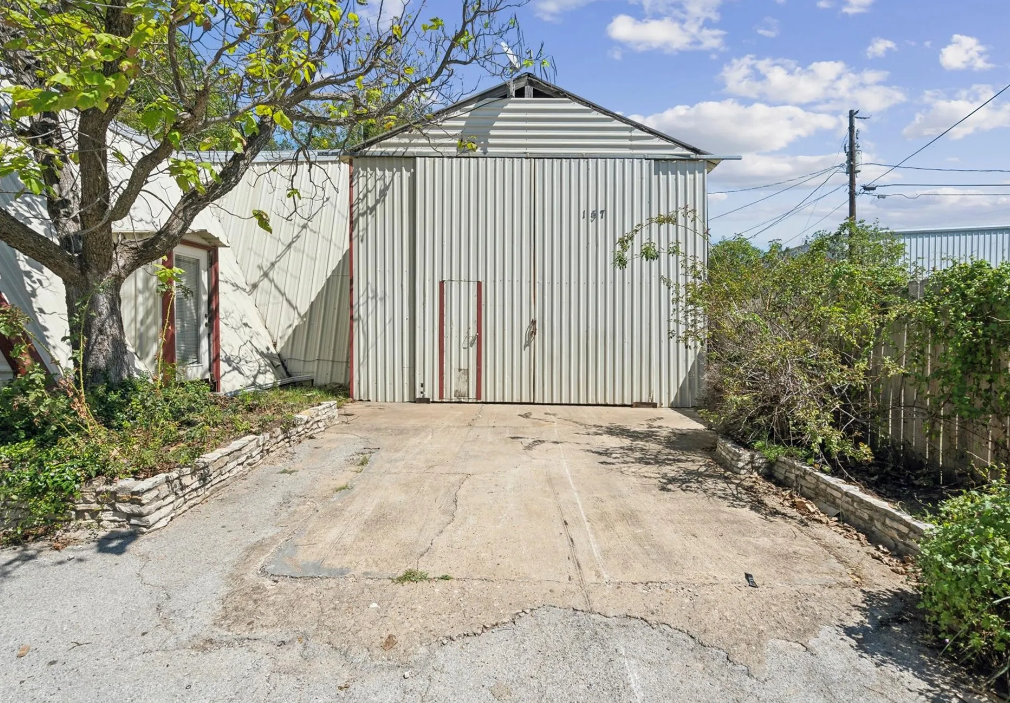View of outdoor structure with fence and an outdoor structure