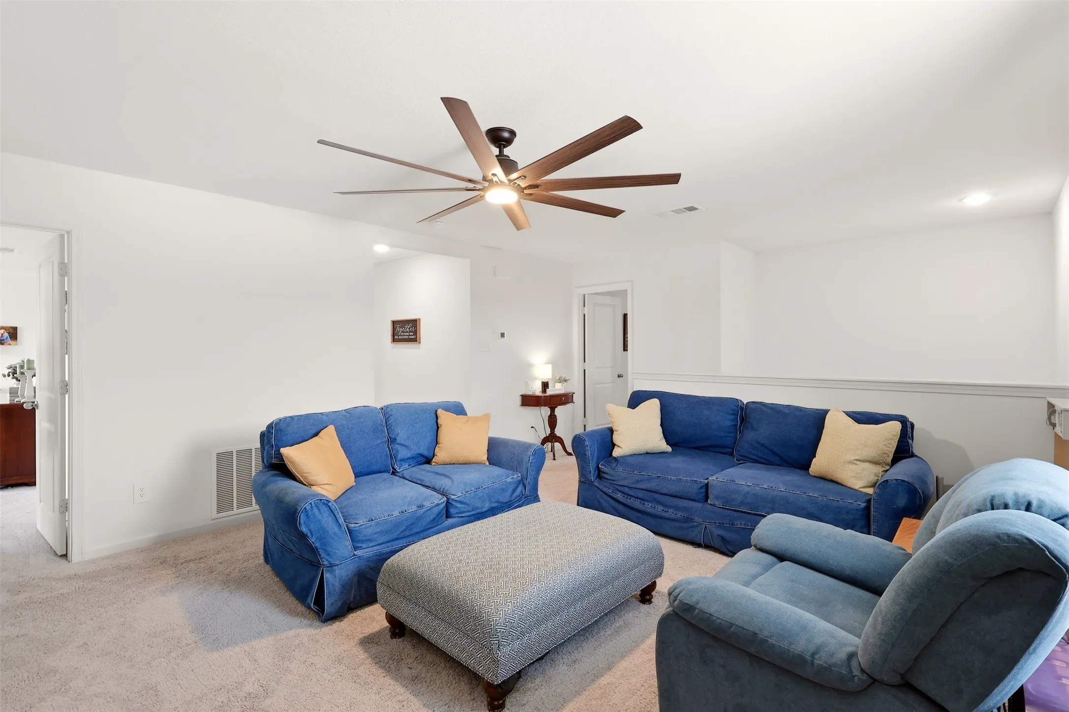 Carpeted floor with a ceiling fan, recessed lighting.