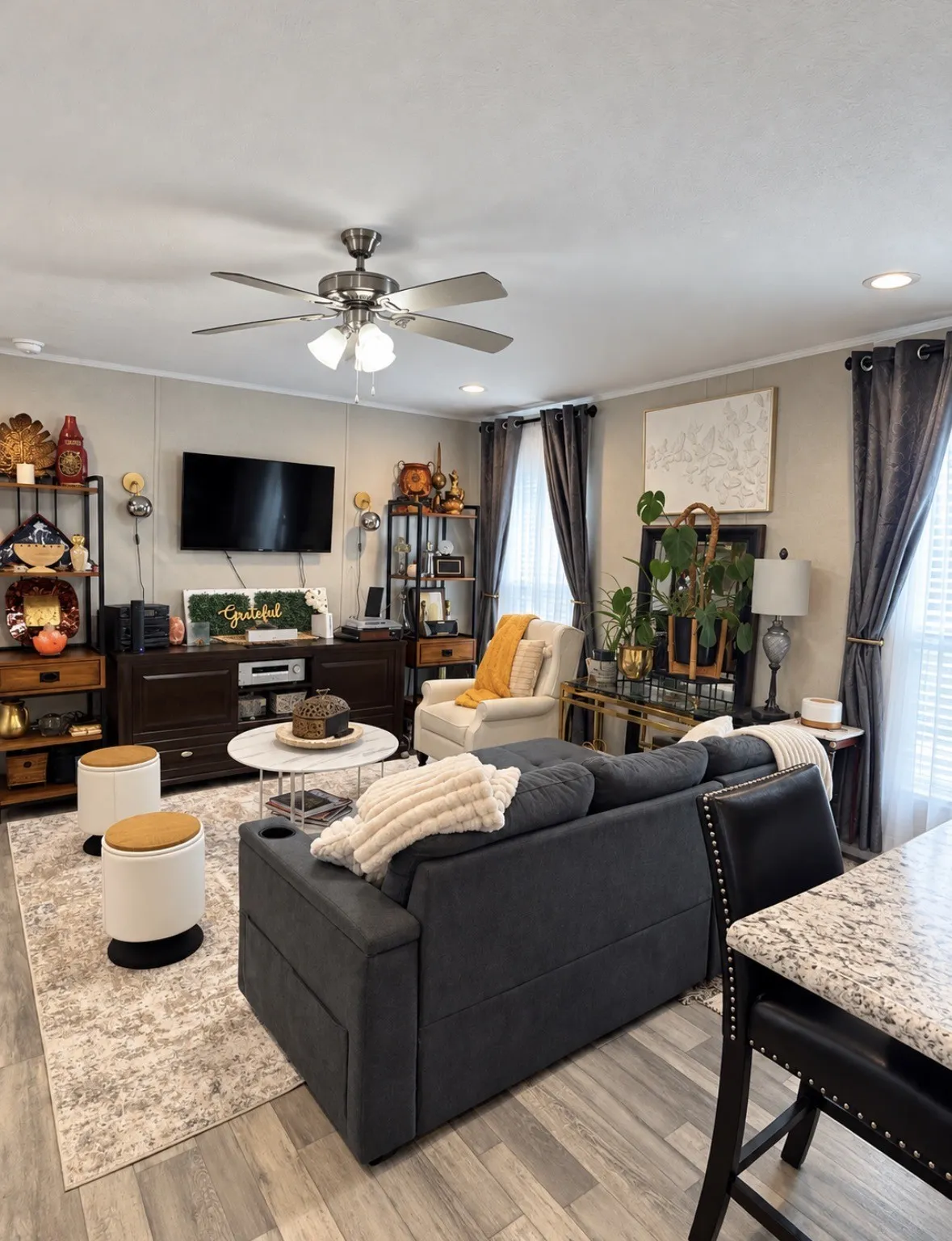 Wood-finish flooring throughout, ceiling fan with integrated lighting, recessed lighting, and shelving units