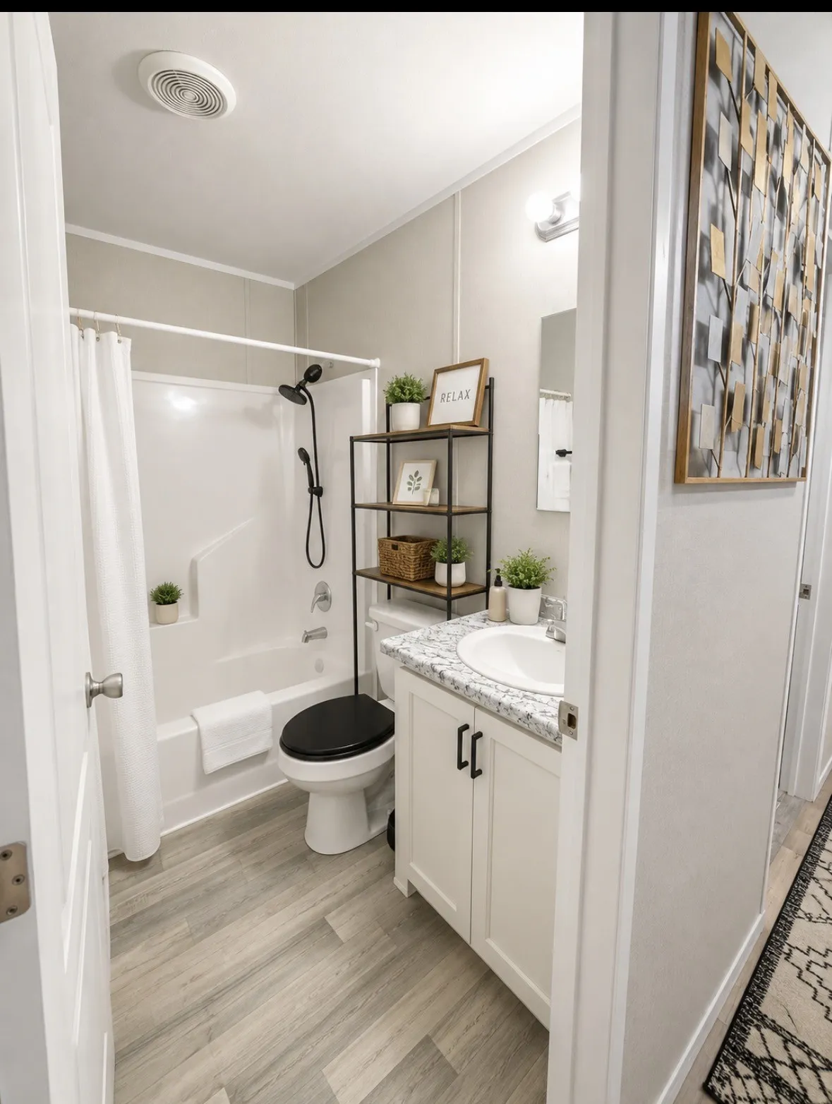 White vanity with black cabinet pulls, granite countertop, and integrated sink