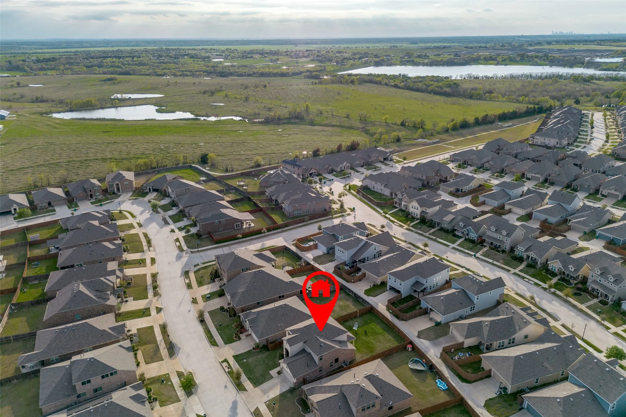 Residential community with a variety of housing styles, established neighborhood infrastructure, and surrounding natural landscape with bodies of water