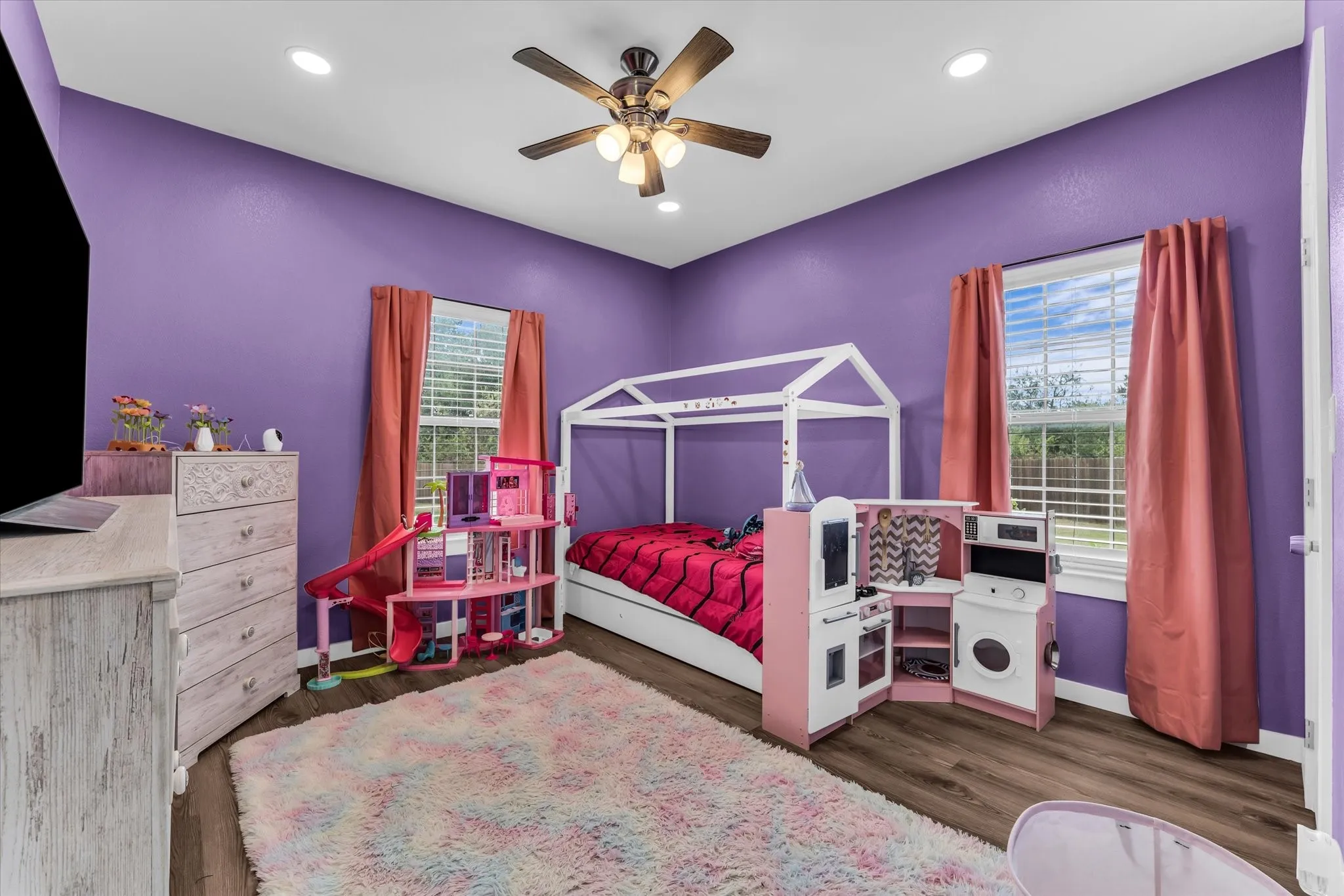Room featuring wood-finish flooring, recessed lighting, and a ceiling fan with integrated light