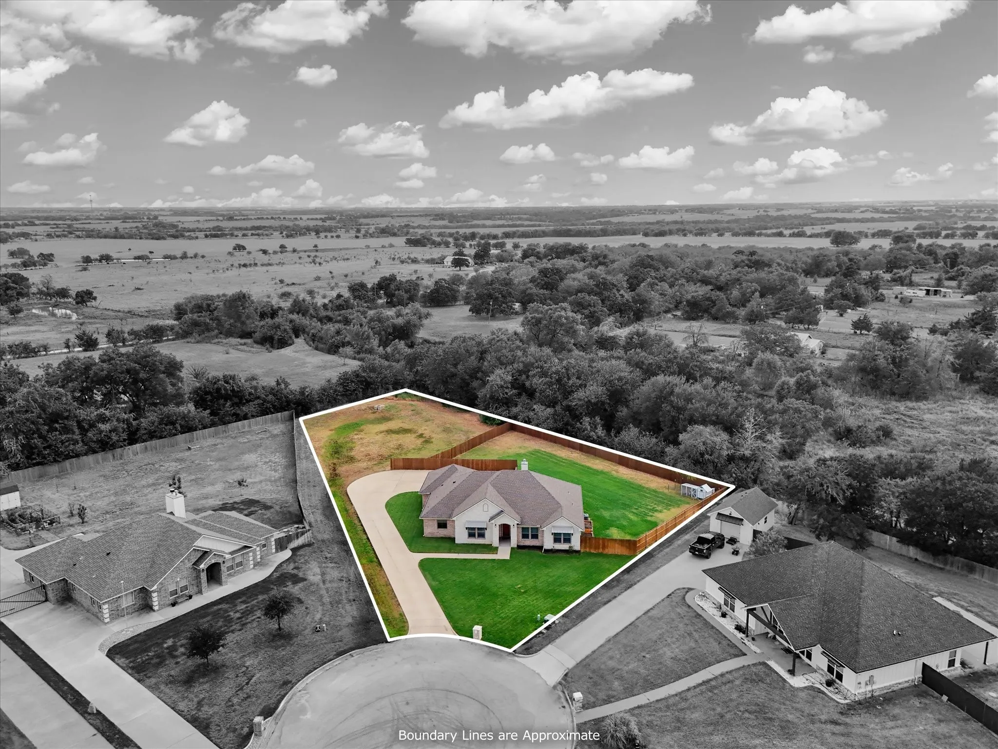Single-story residence on a cul-de-sac lot featuring a paved driveway, manicured lawn, and wood privacy fencing