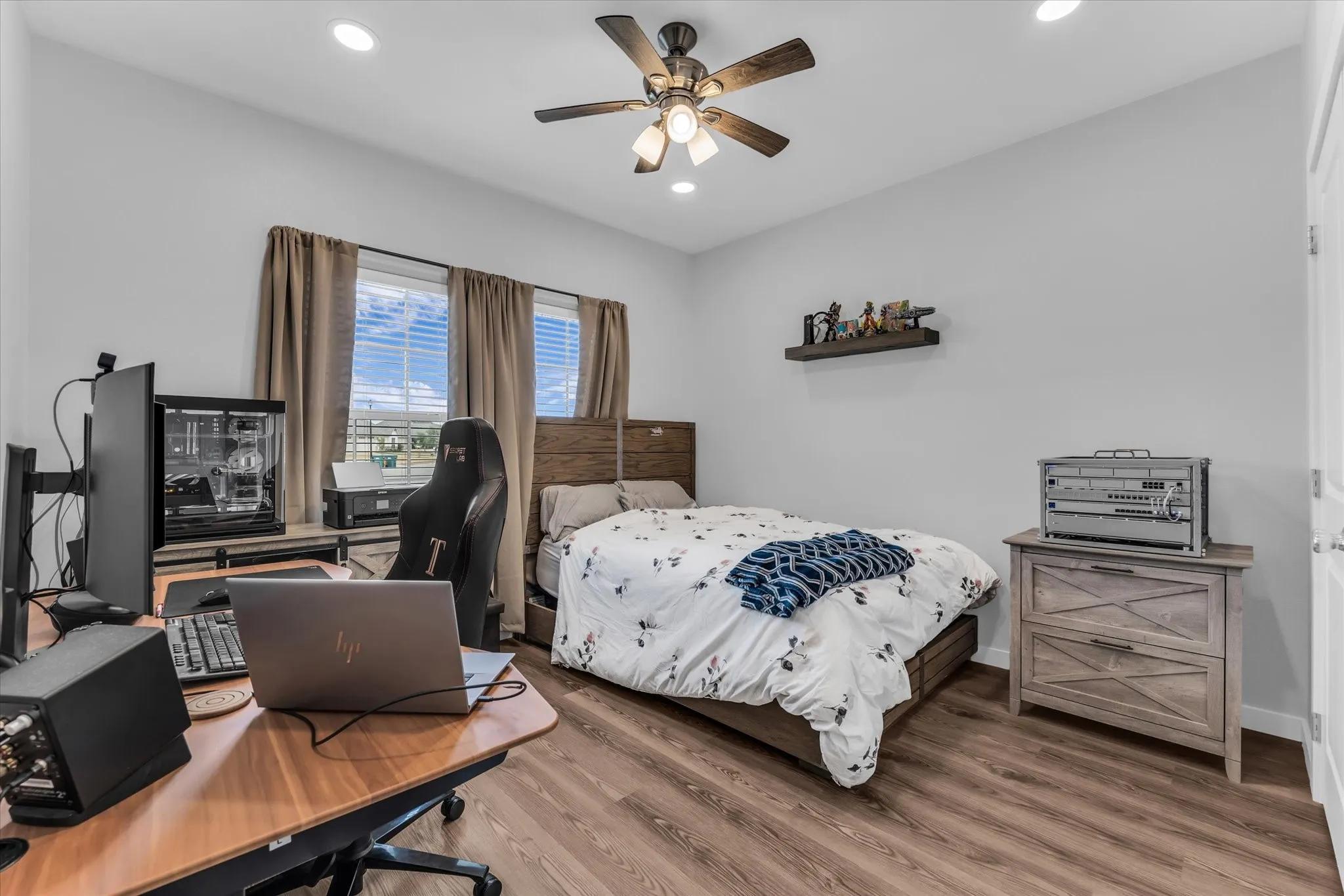 Wood-finish flooring, recessed lighting, and a ceiling fan with integrated lighting