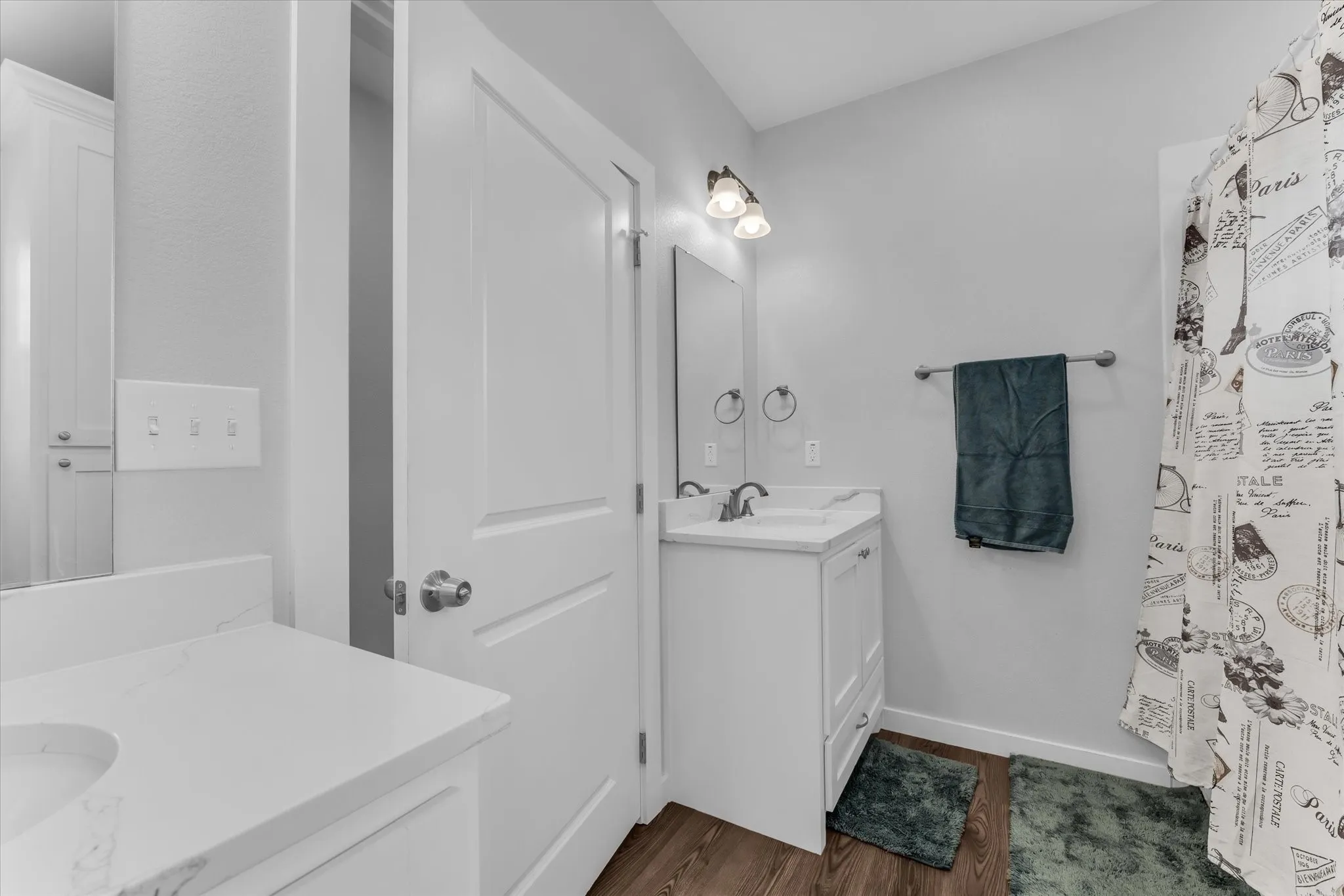 White vanity with a rectangular basin, chrome faucet, and integrated countertop
