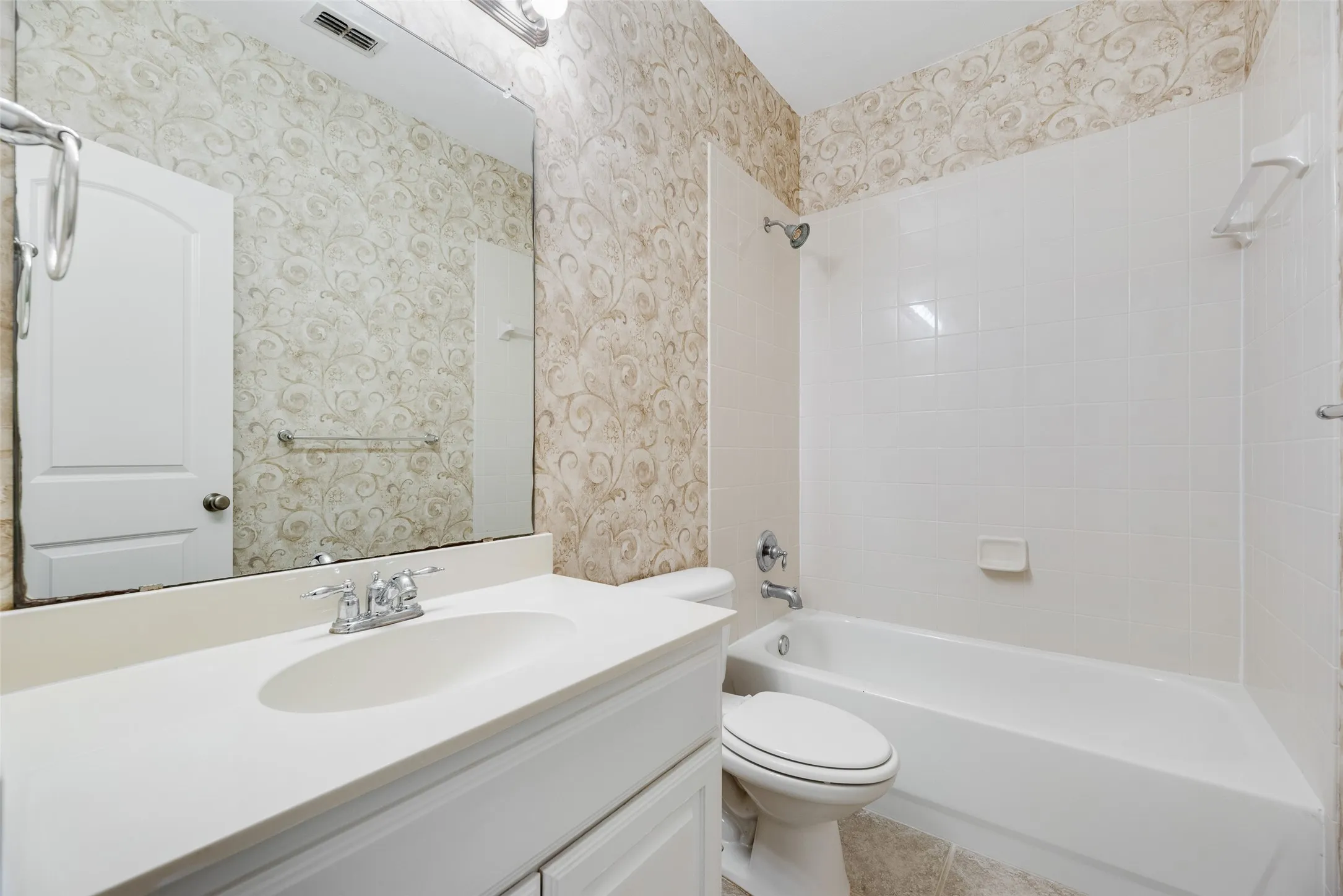 White paneled vanity with an integrated sink, polished chrome faucet, and a wall-mounted mirror