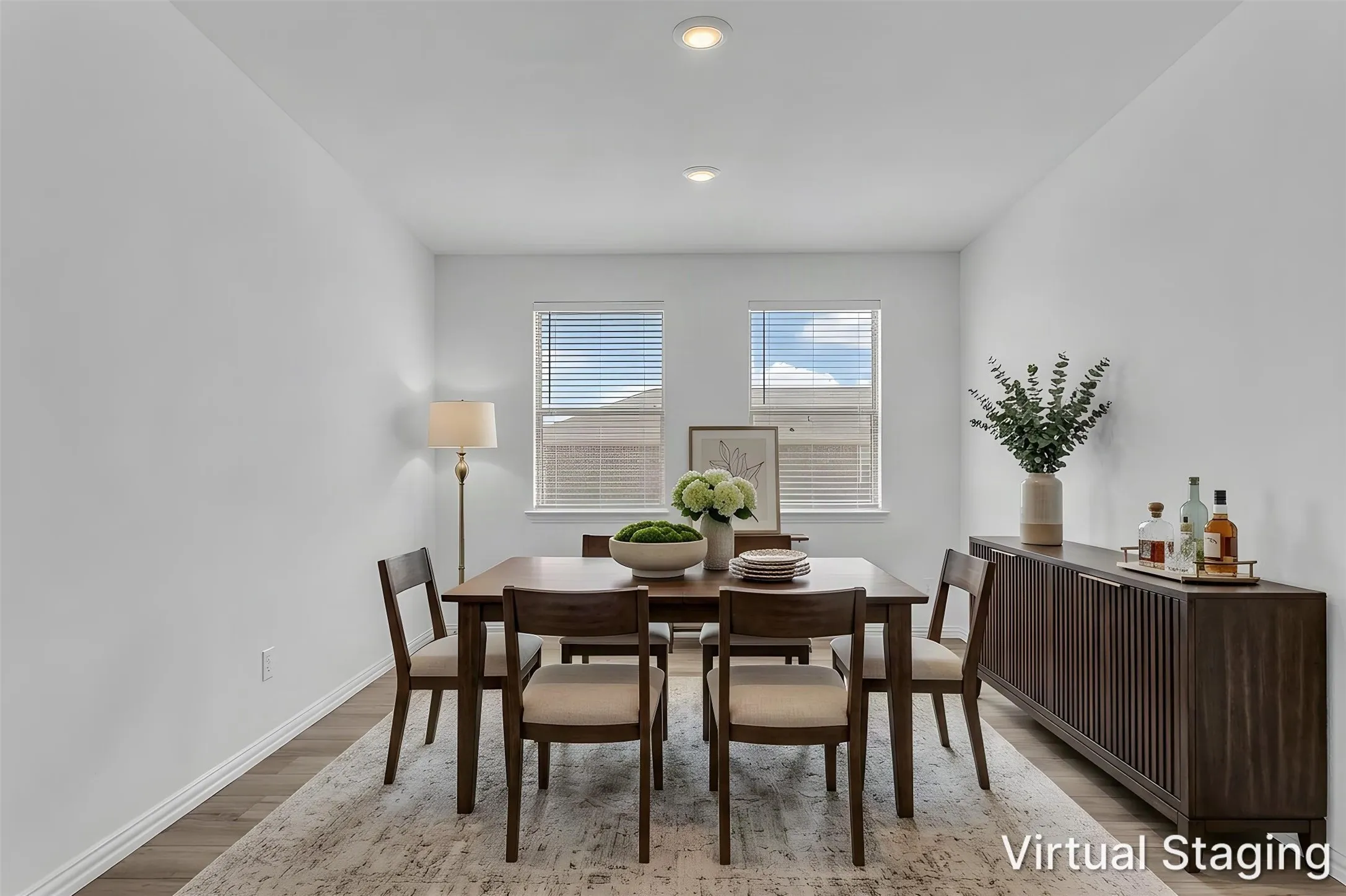 Virtually staged dining room showing one way to furnish the space, with two windows and recessed lighting