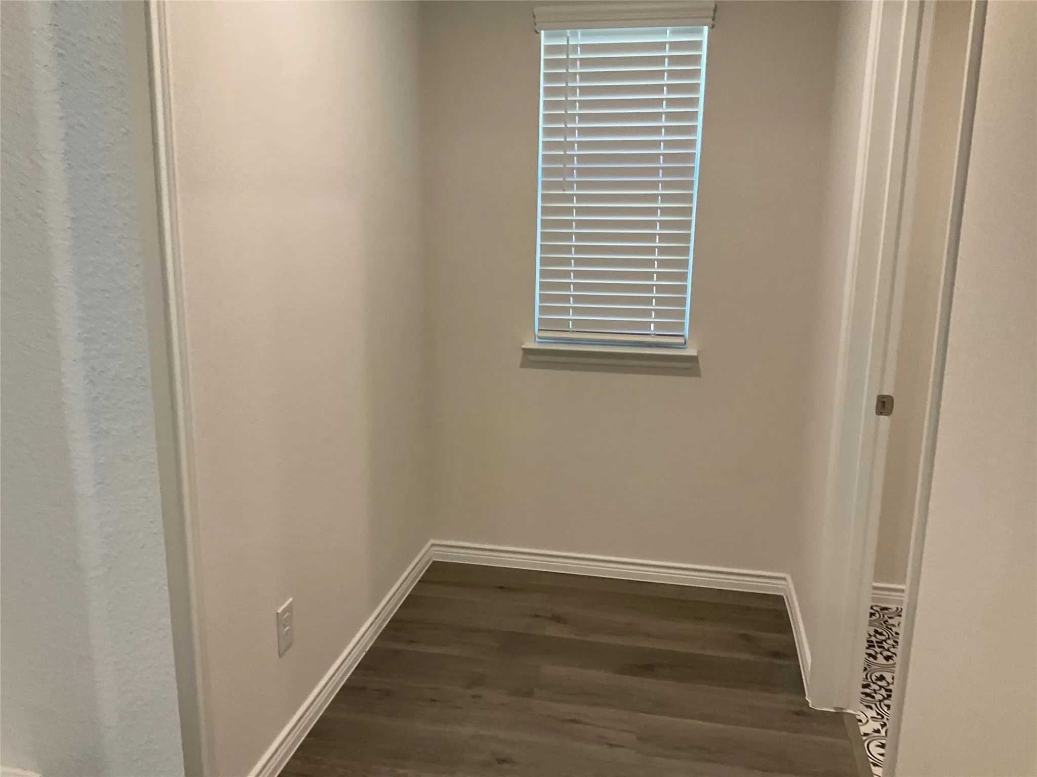 Room details featuring baseboards and wood finished floors