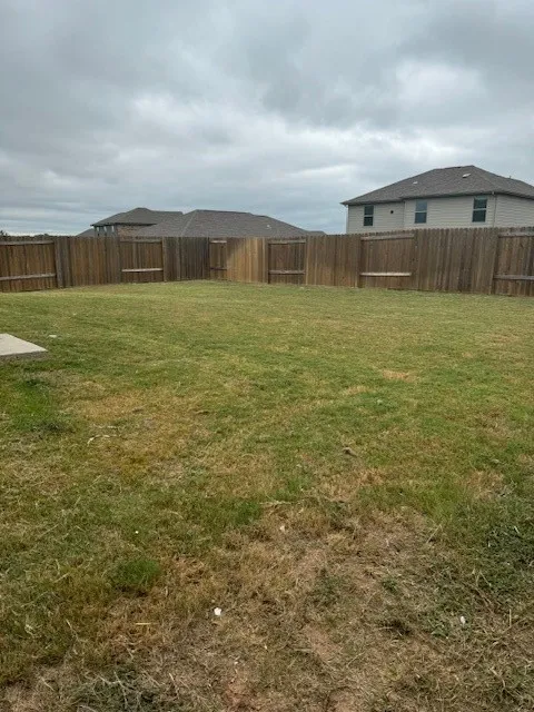 Expansive backyard featuring a wood privacy fence