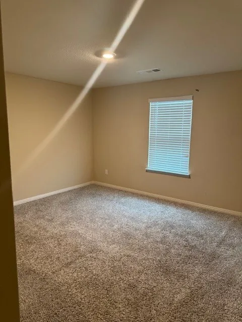 Carpeted flooring, recessed ceiling lighting, light-toned wall paint, white window blinds, and white trim molding