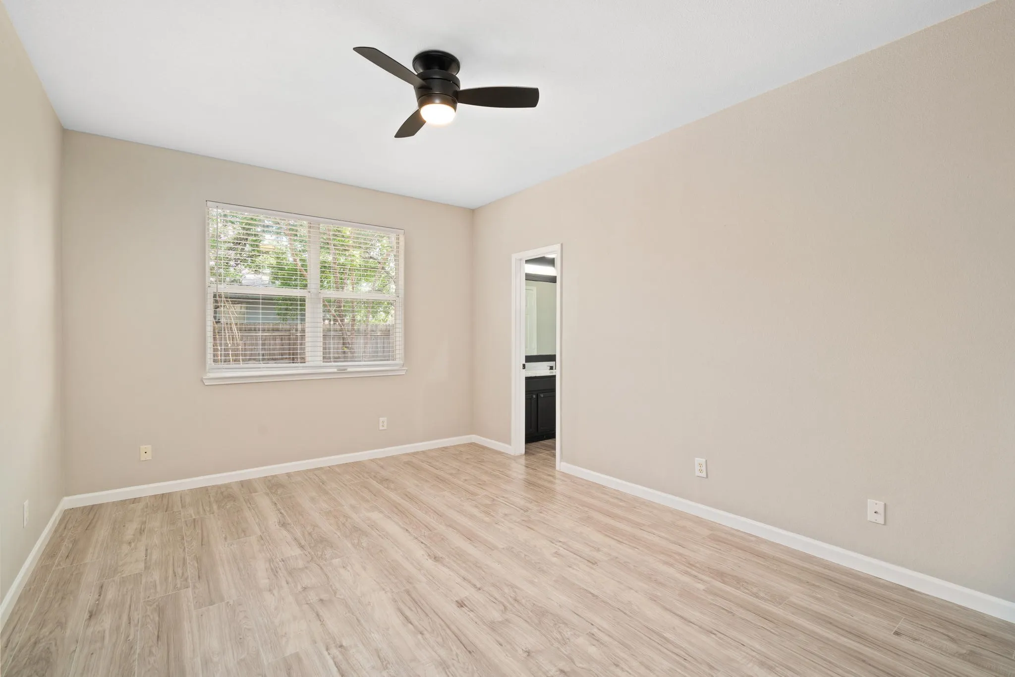 The spacious primary suite is light and bright.