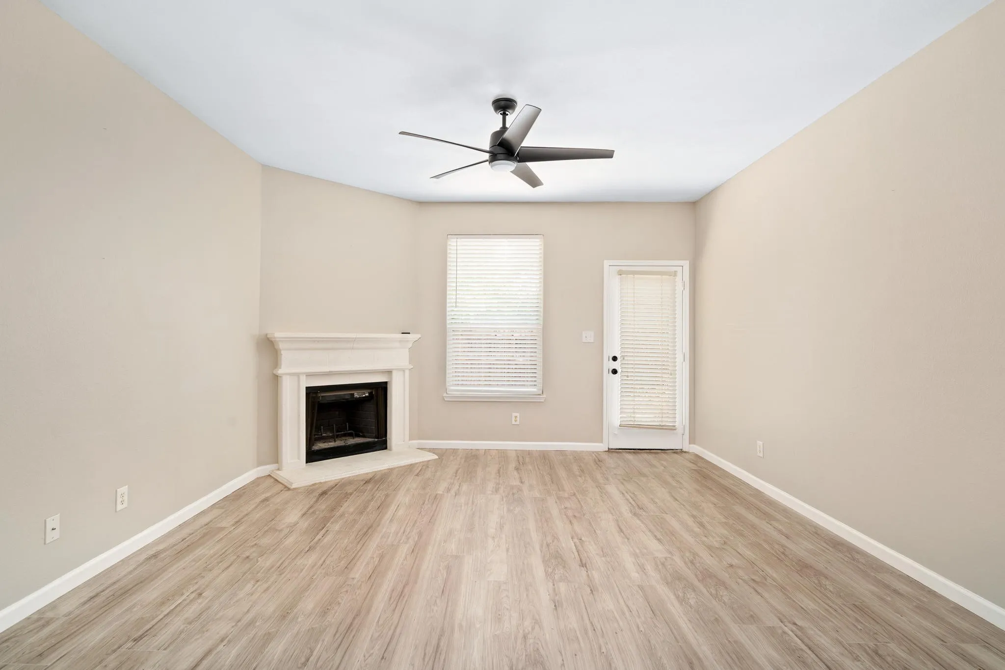 The cozy family room is anchored with a wood burning fireplace.