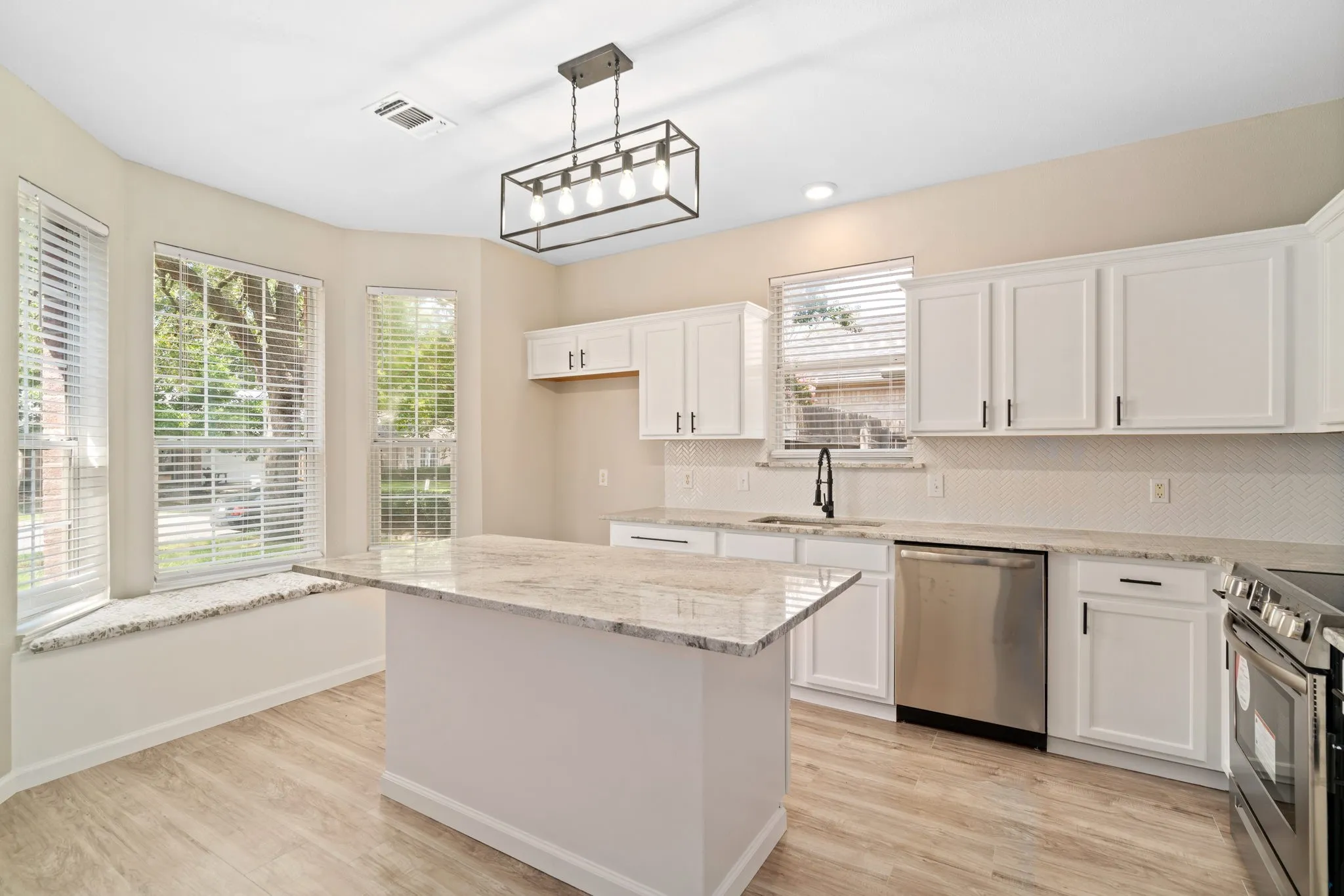 The chef's kitchen at 3957 Parkhaven Drive features granite counters, stainless steel appliances and plenty of cabinets for storage.