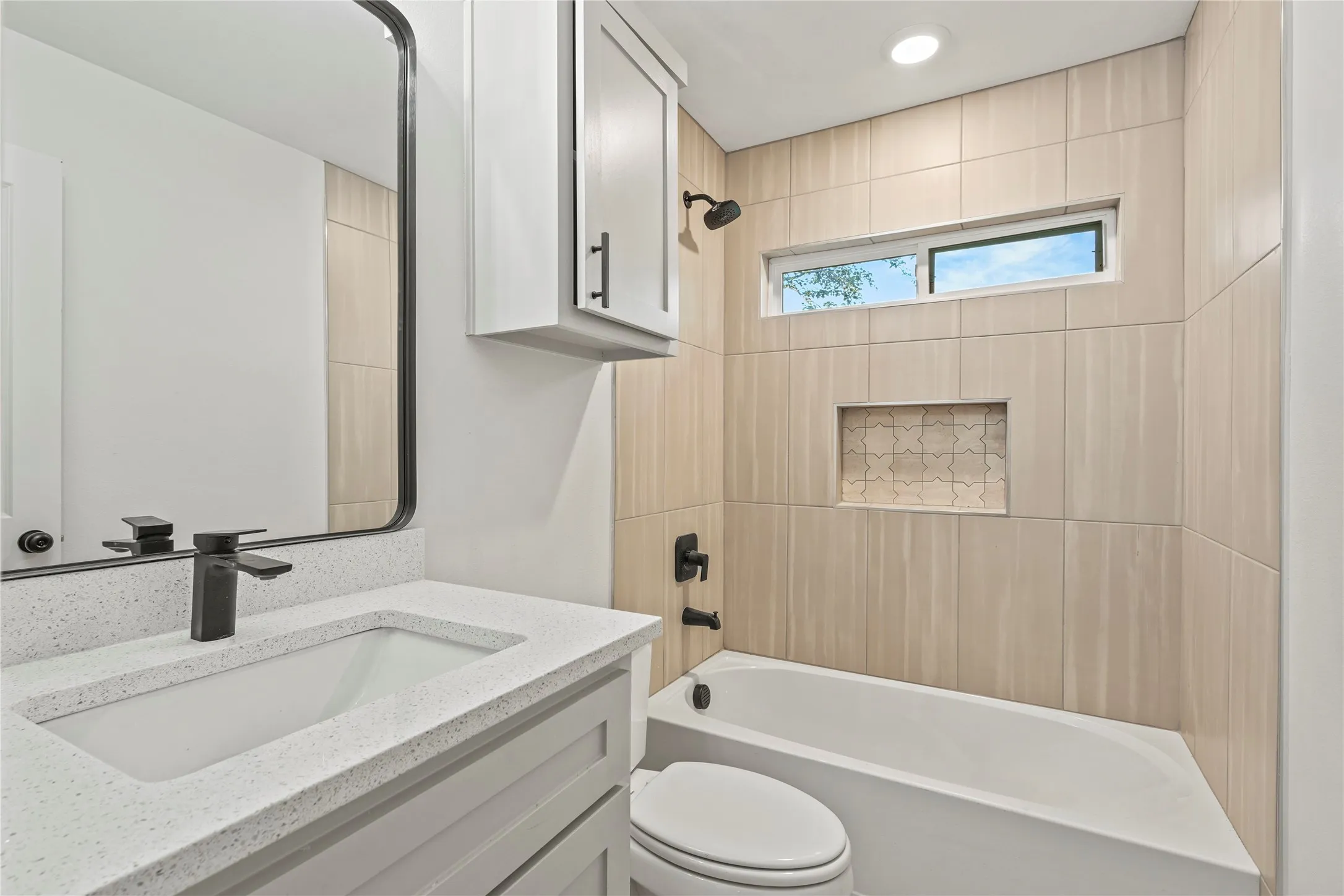 Bathroom featuring vanity, bathtub / shower combination, and toilet