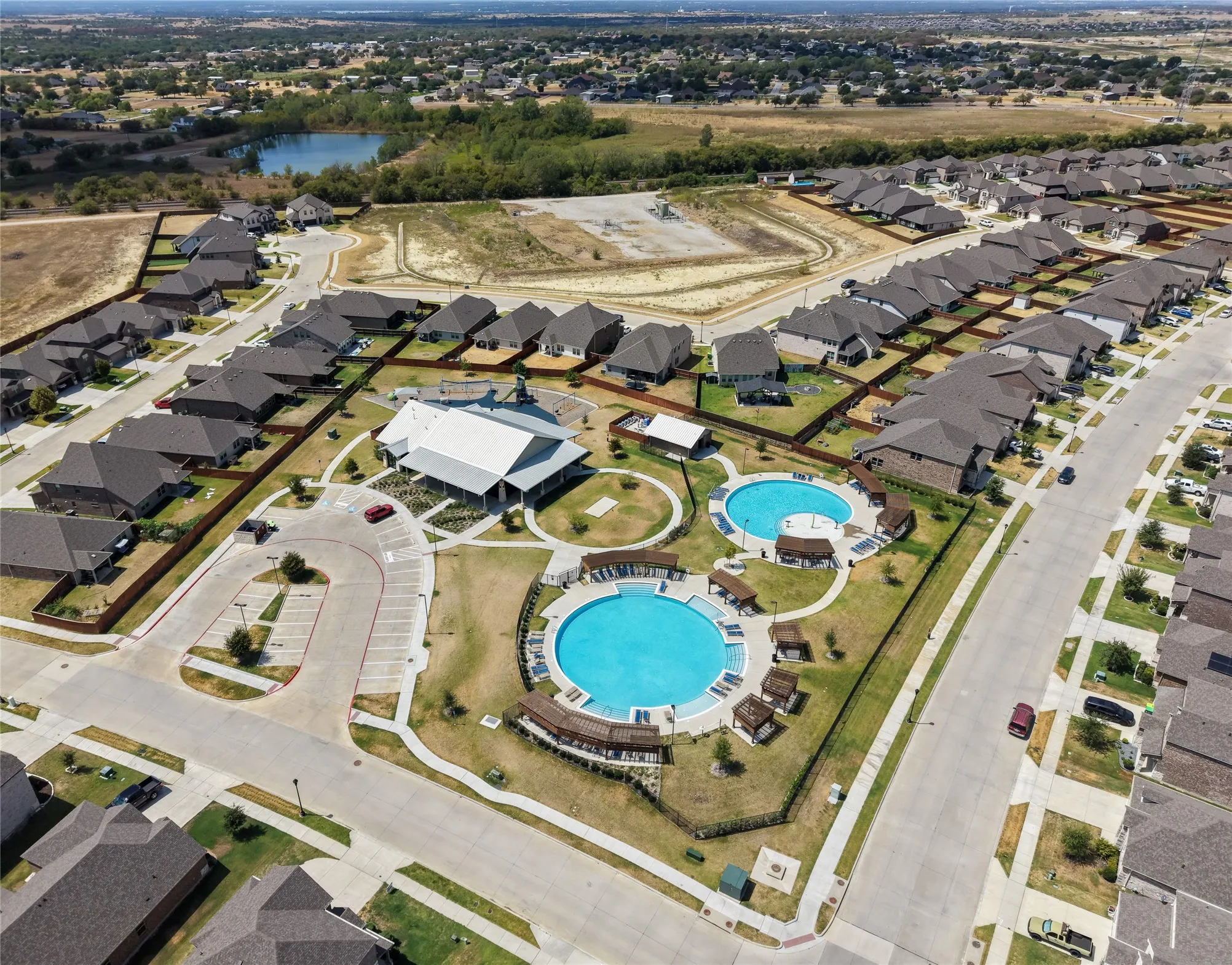 Community amenities include two swimming pools, a central clubhouse, and dedicated parking