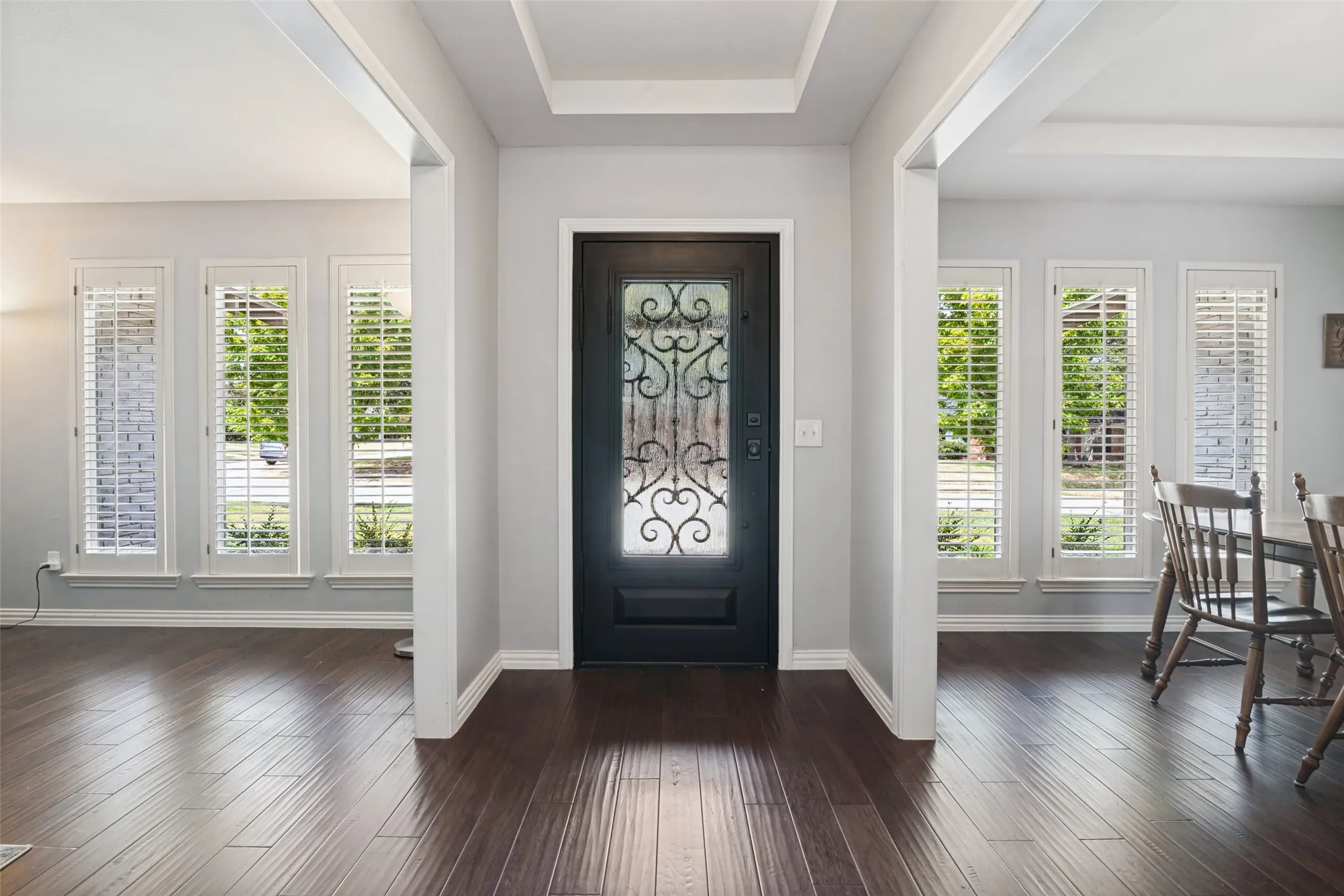 Entry featuring a dark-finish door with decorative ironwork