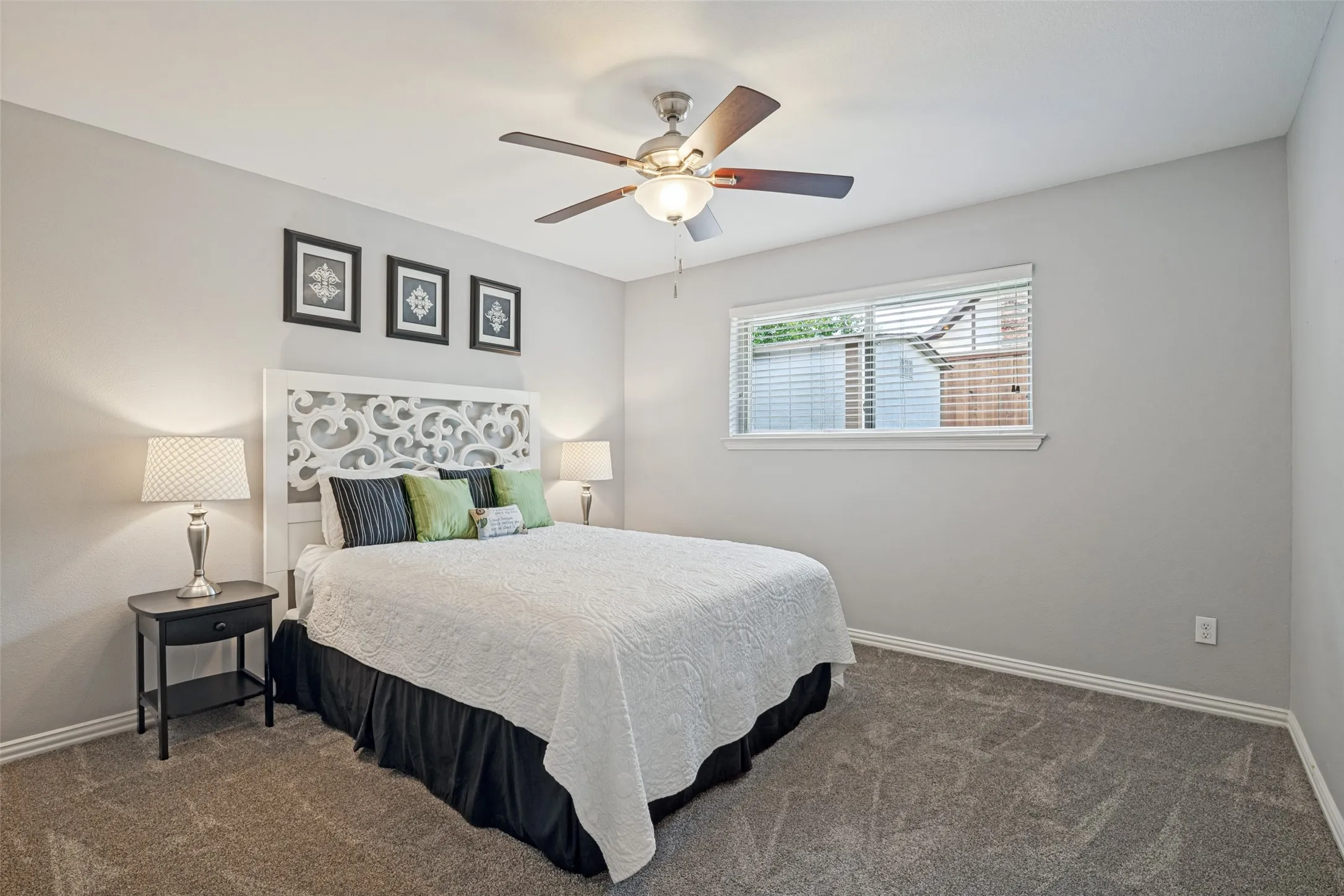Carpeted flooring, window with blinds, ceiling fan with integrated lighting, and neutral wall paint
