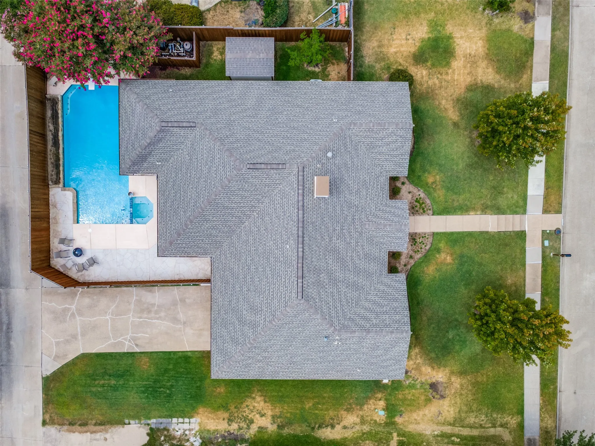 Private backyard with a swimming pool and attached spa