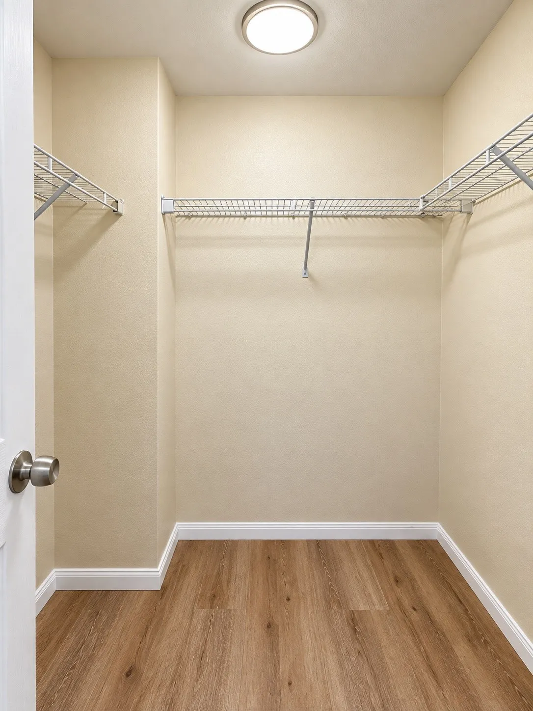 Walk-in closet featuring wood-finish flooring, white trim, recessed lighting, and built-in wire​​‌​​​​‌​​‌‌​‌‌​​​‌‌​‌​‌​‌​​​‌​​ shelving