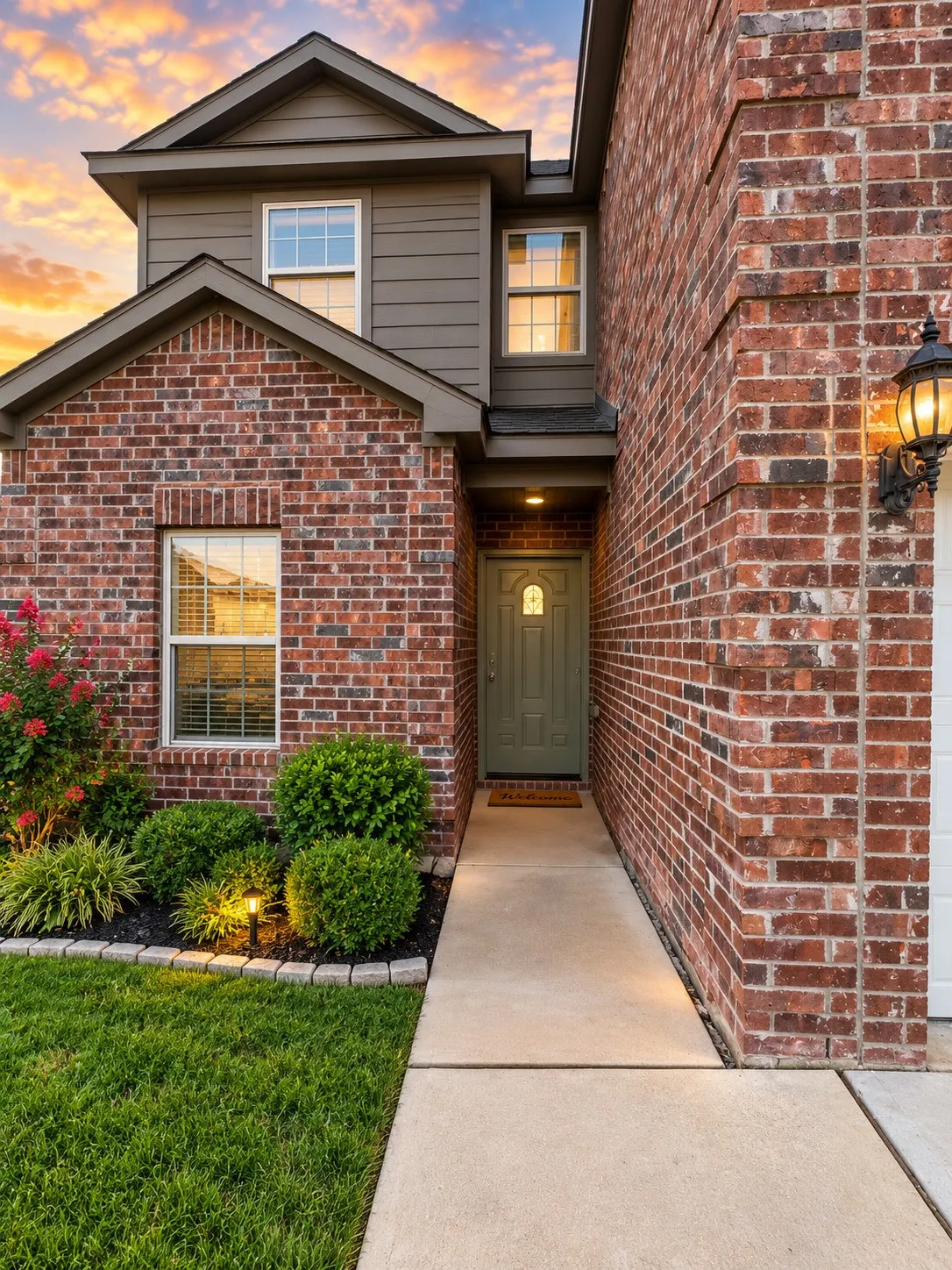 Brick and siding exterior with a front entry door