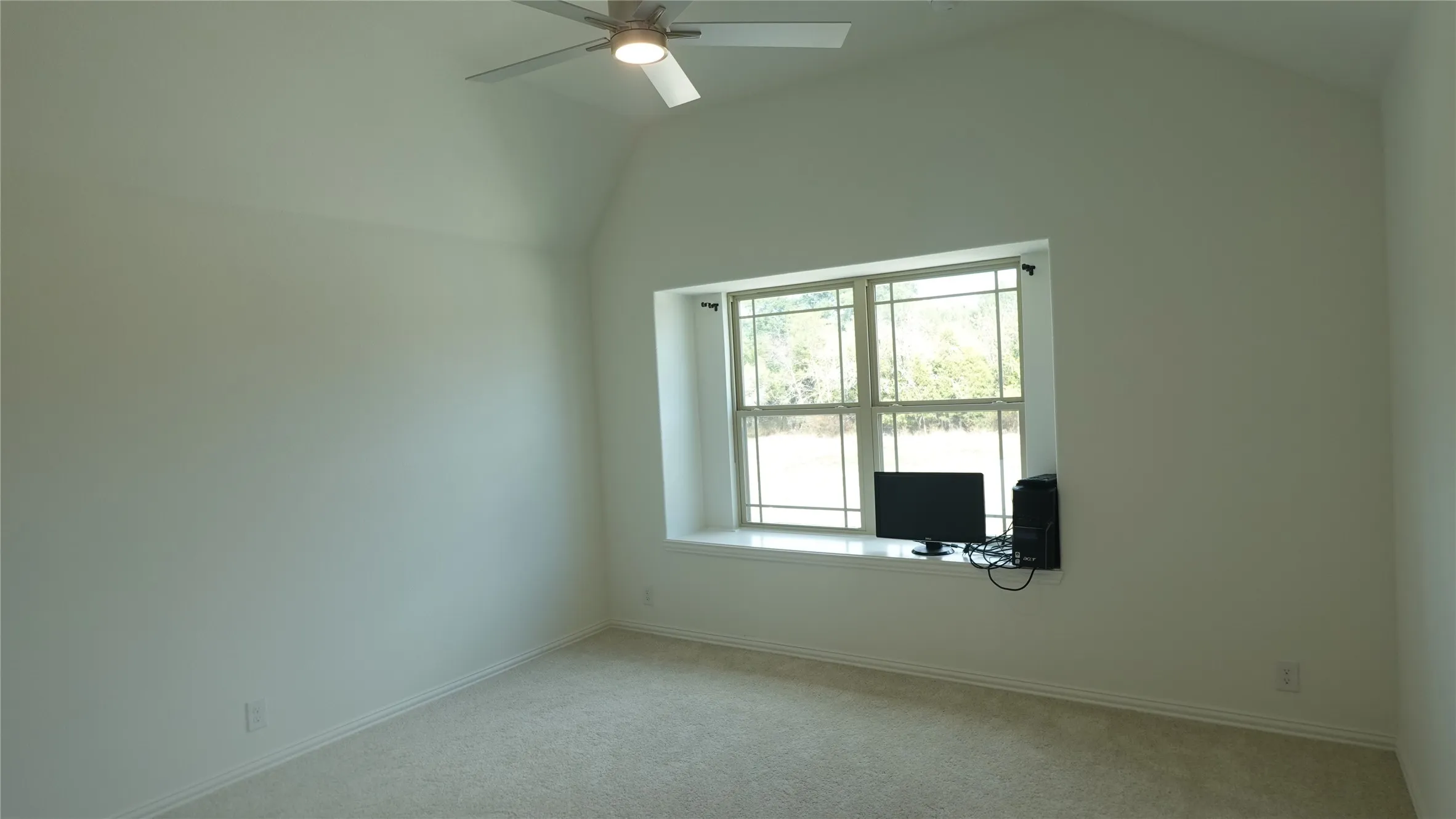 Bedroom 3 with ceiling fan, recessed window with a window seat, and neutral carpeted flooring