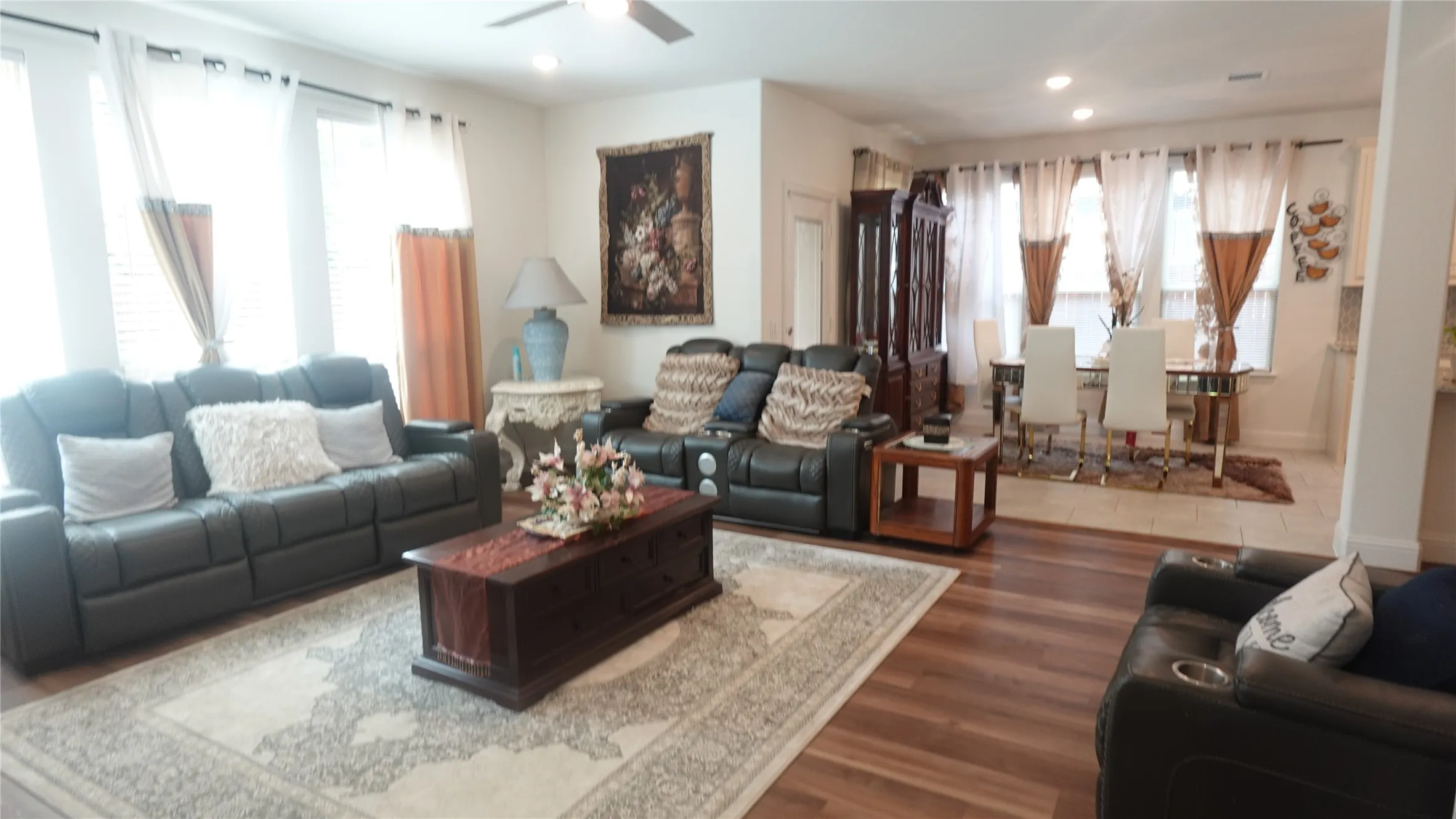 Expansive living area featuring wood-finish flooring, recessed lighting, and a ceiling fan