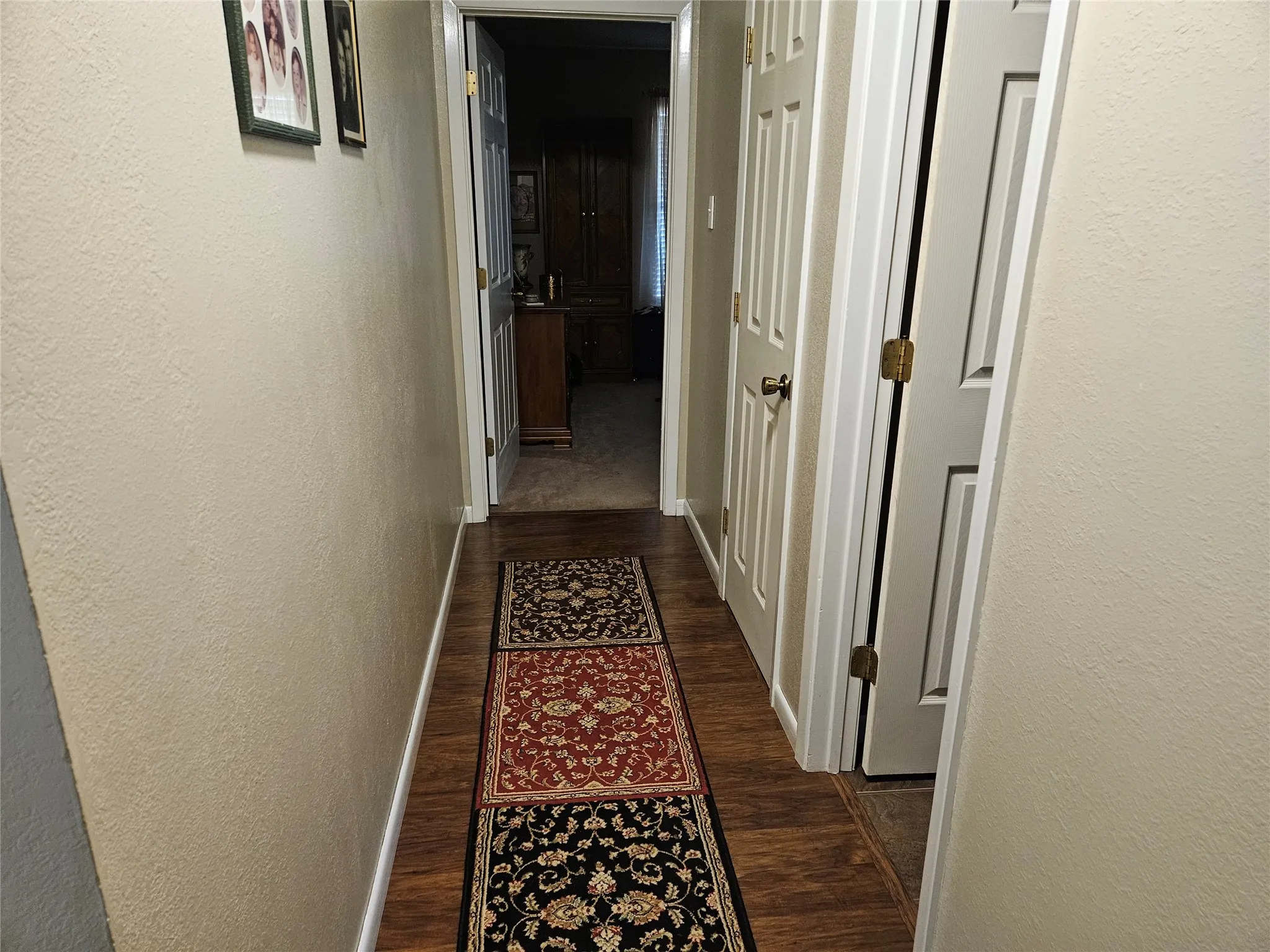 Wood-finish flooring with neutral wall tones leading to Bedroom #2