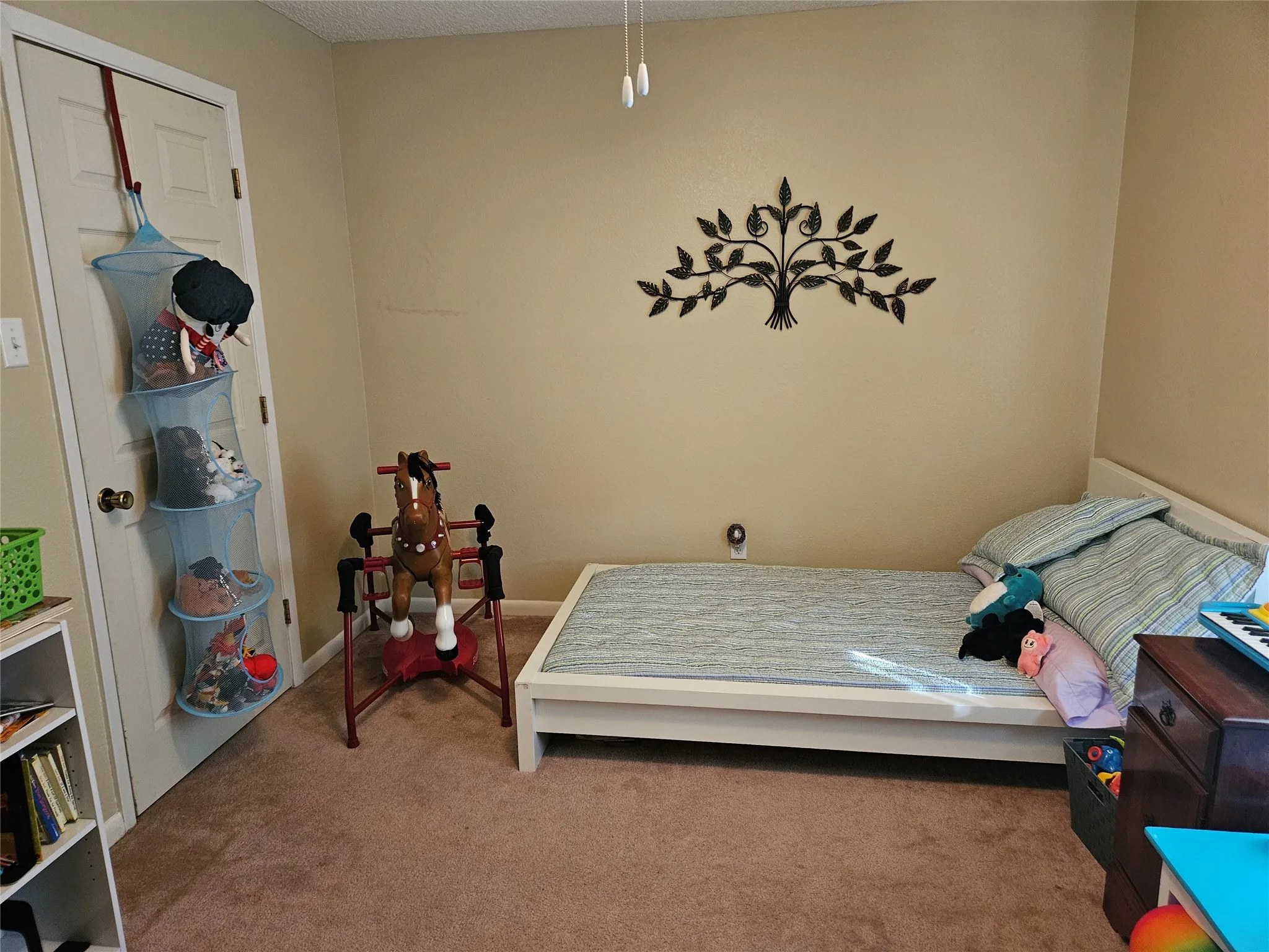 Neutral painted walls, carpeted flooring, and a white interior door