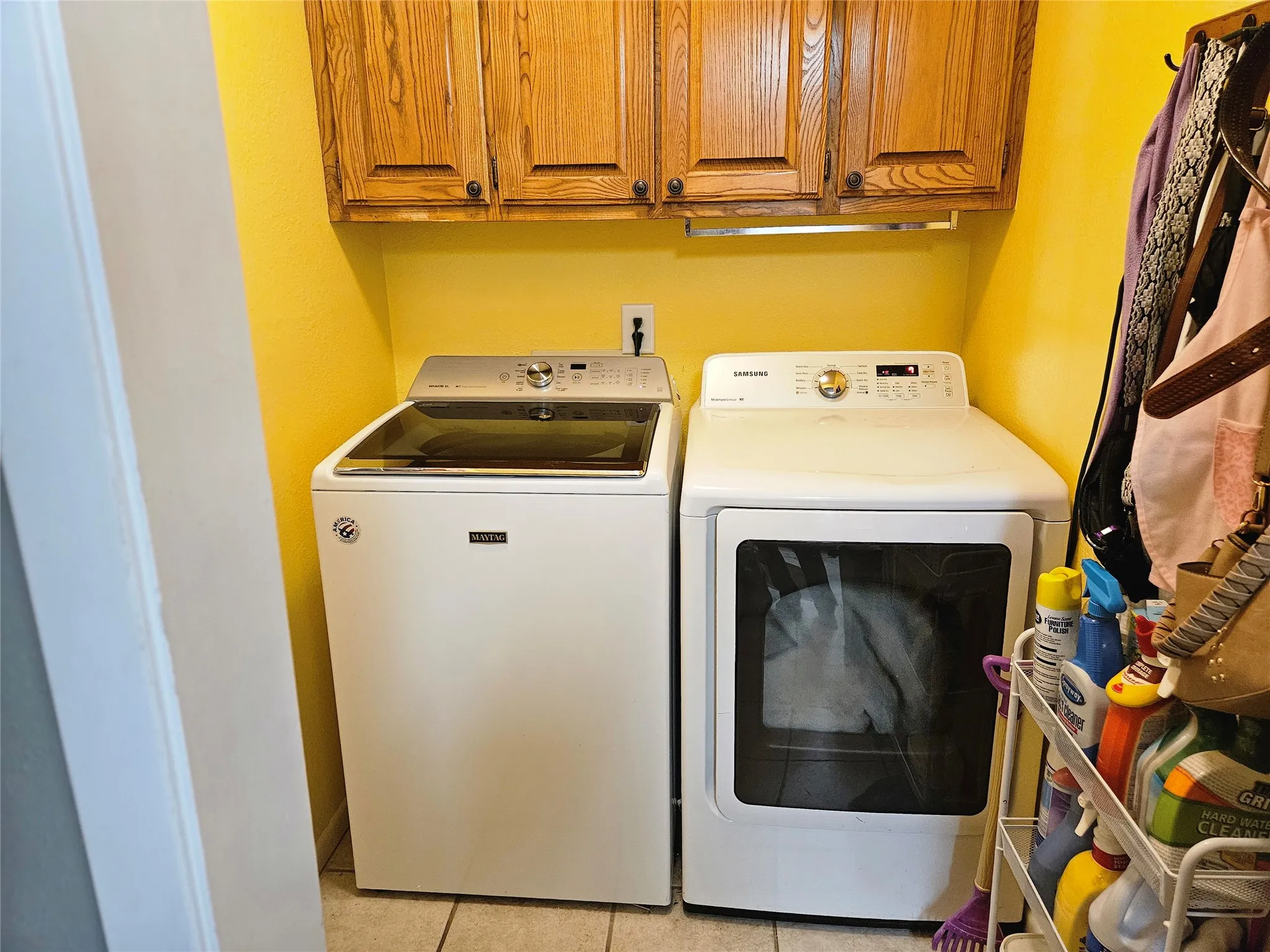 Built-in cabinetry with wood-finish doors and under-cabinet lighting with full size washer and dryer connections