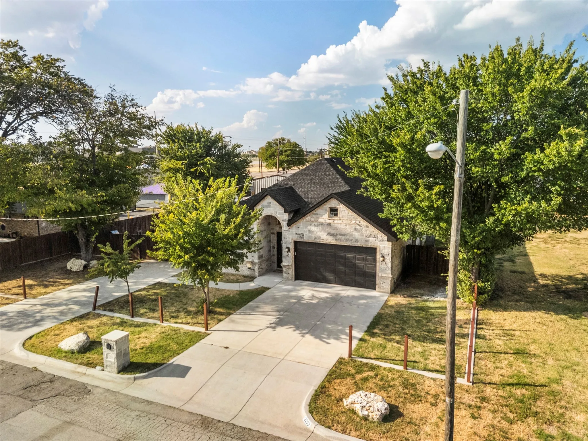 Stone veneer exterior with dark shingle roof