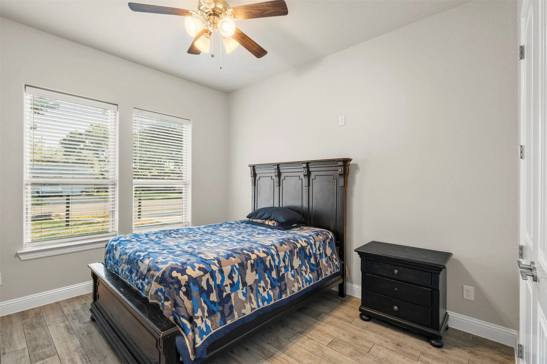 Wood-finish flooring with crisp white baseboards