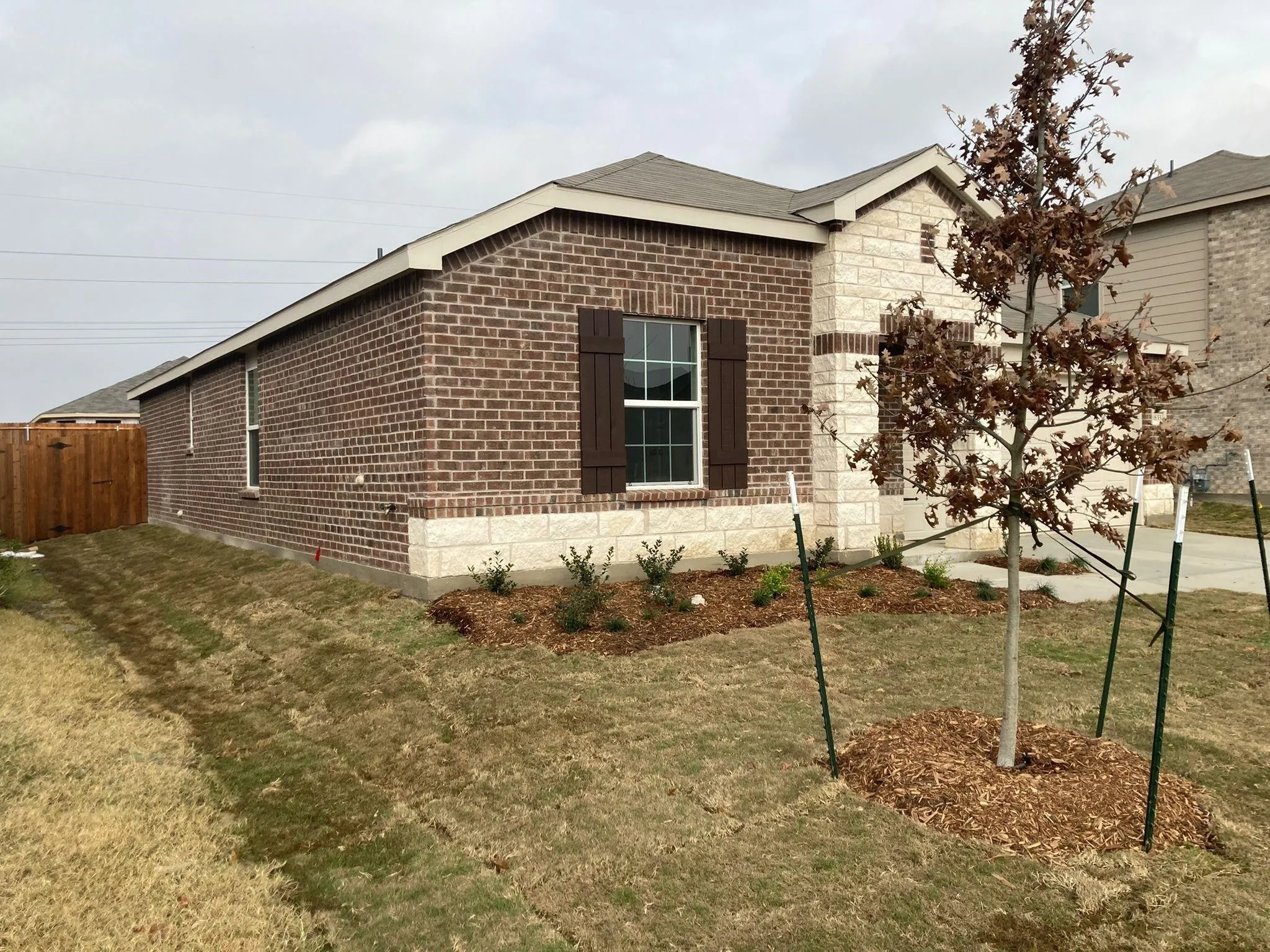 Brick and stone exterior with decorative shutters