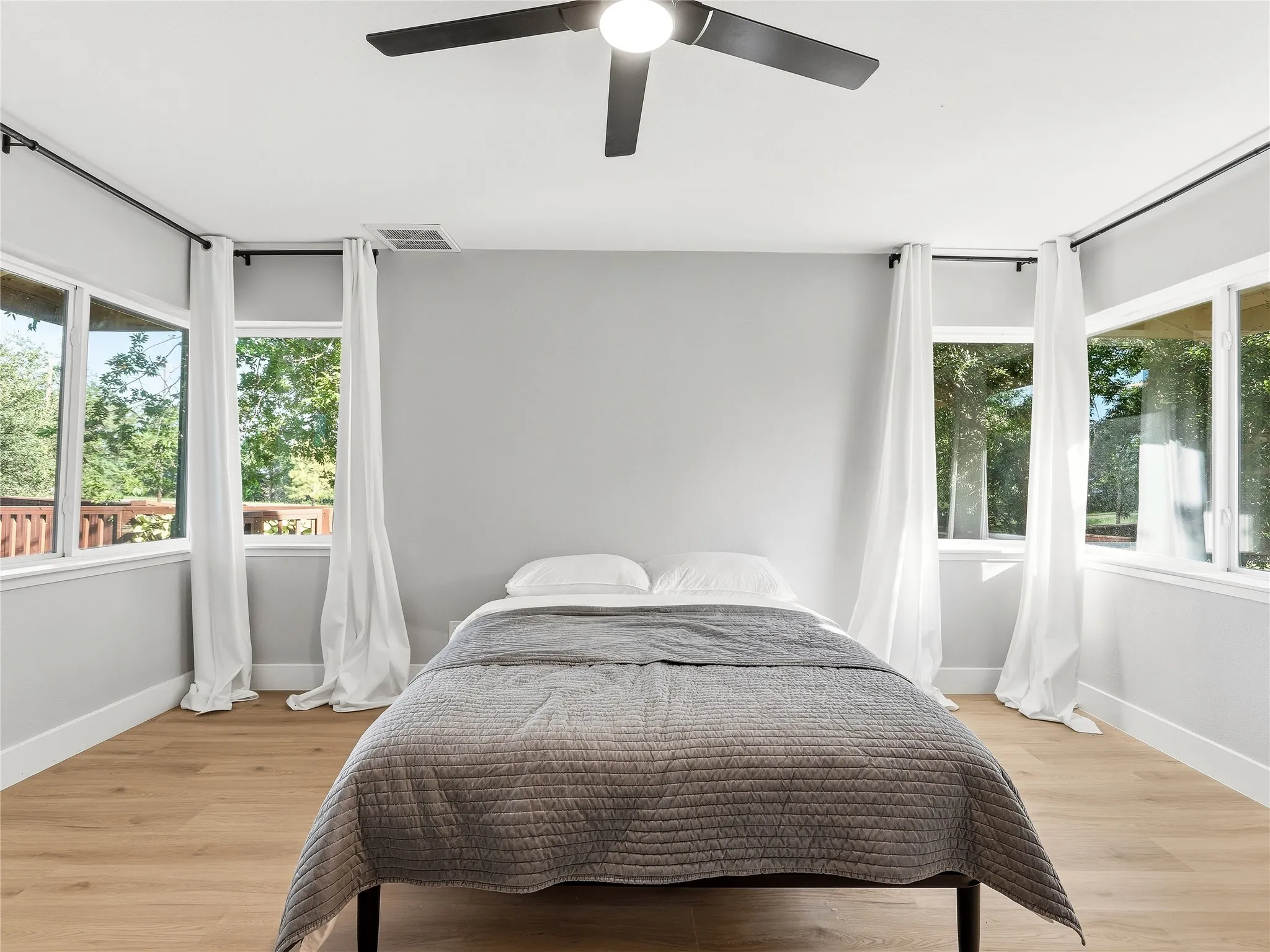 Recessed lighting, wood-finish flooring, ceiling fan, and multiple windows