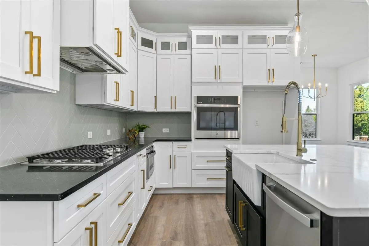 Lovely kitchen with gas cooktop, stainless steel appliances and lighted upper cabinets.