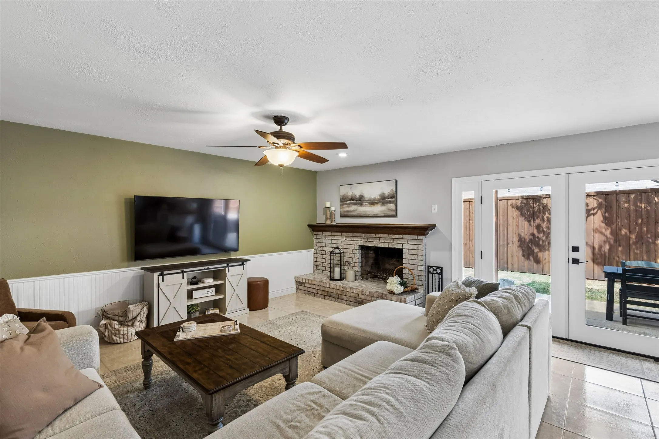 Room enough for a full sectional, with French doors framing a straight shot to the covered patio.