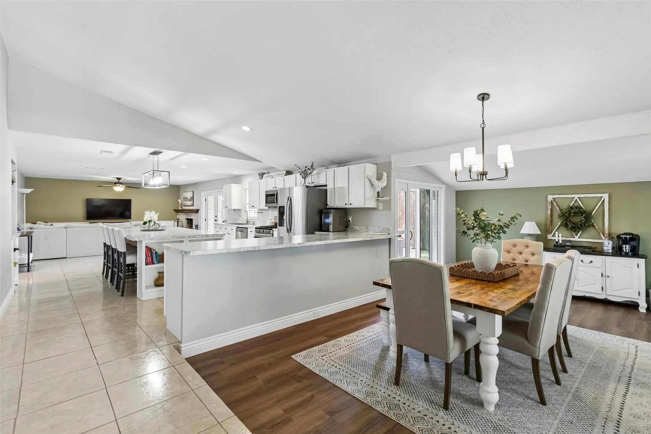 Built for hosting — the island anchors an open kitchen that flows straight into the dining room and living room beyond.