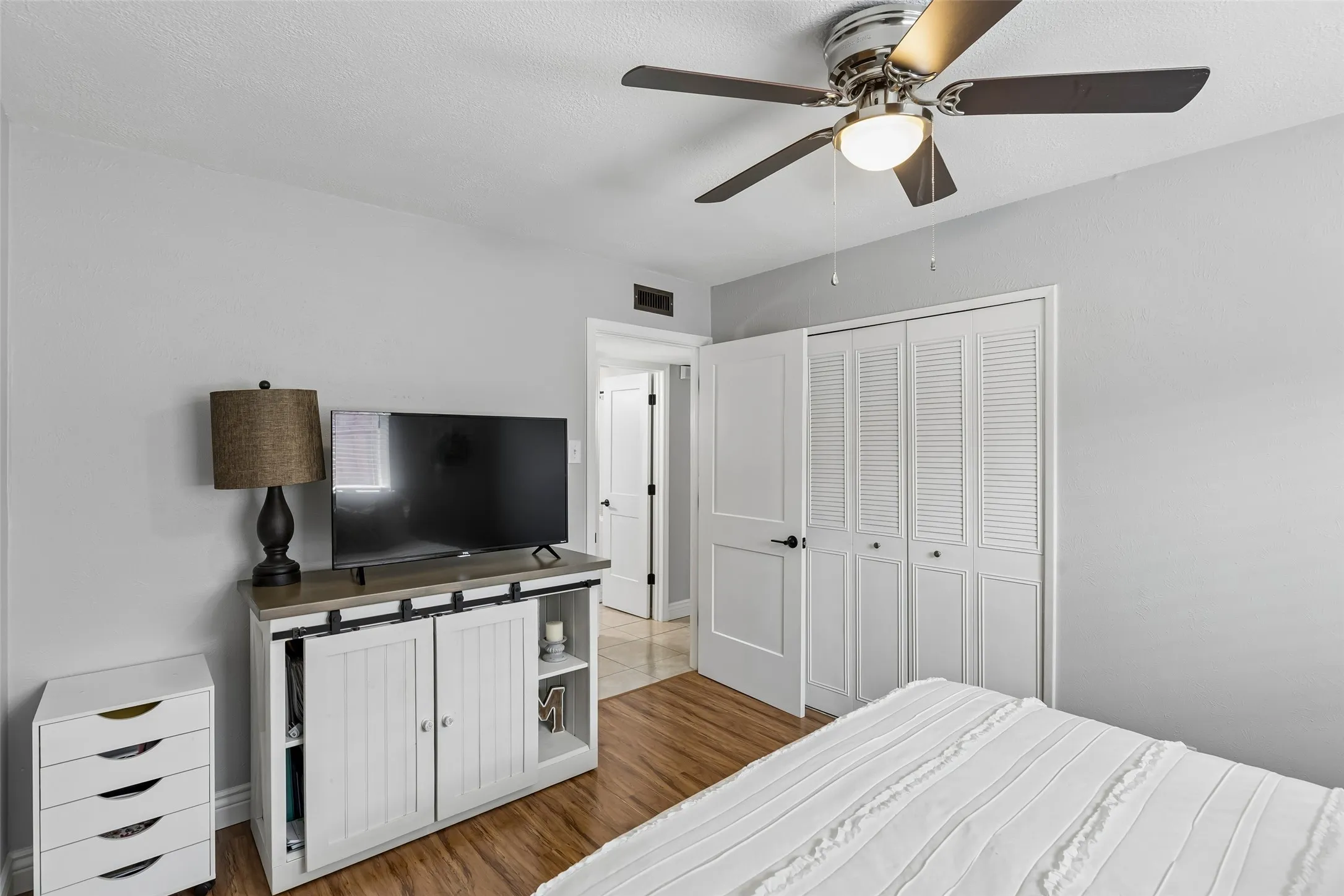 A dedicated closet and natural light keep this secondary bedroom simple and functional.