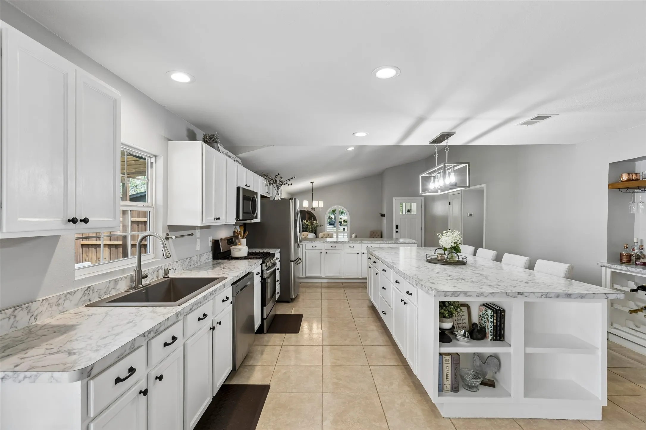 Storage that works as hard as the cooktop — open shelving built into the island keeps cookbooks and extras within reach.
