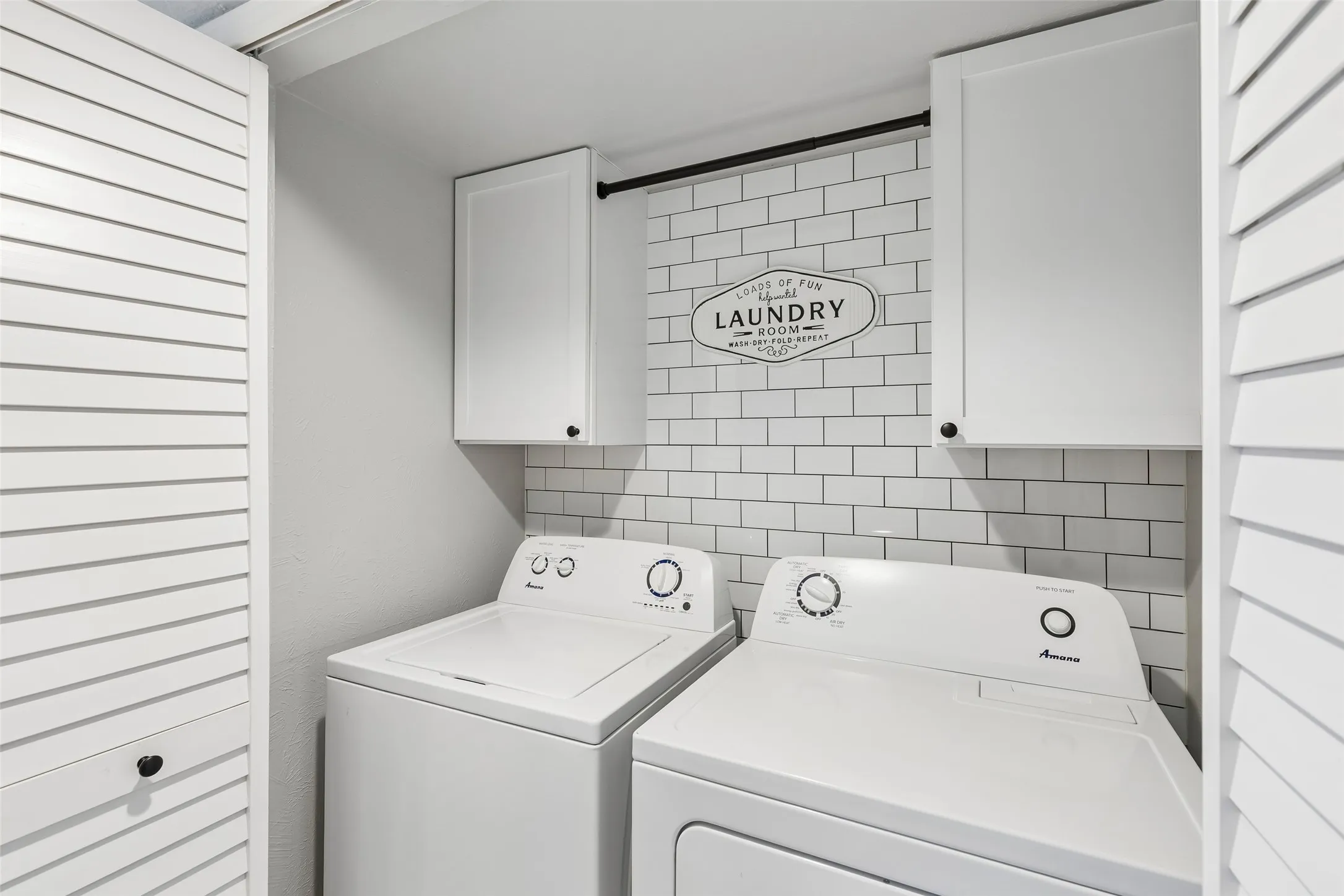 This laundry room's cabinet storage and cheerful styling make an everyday chore feel a little more fun.